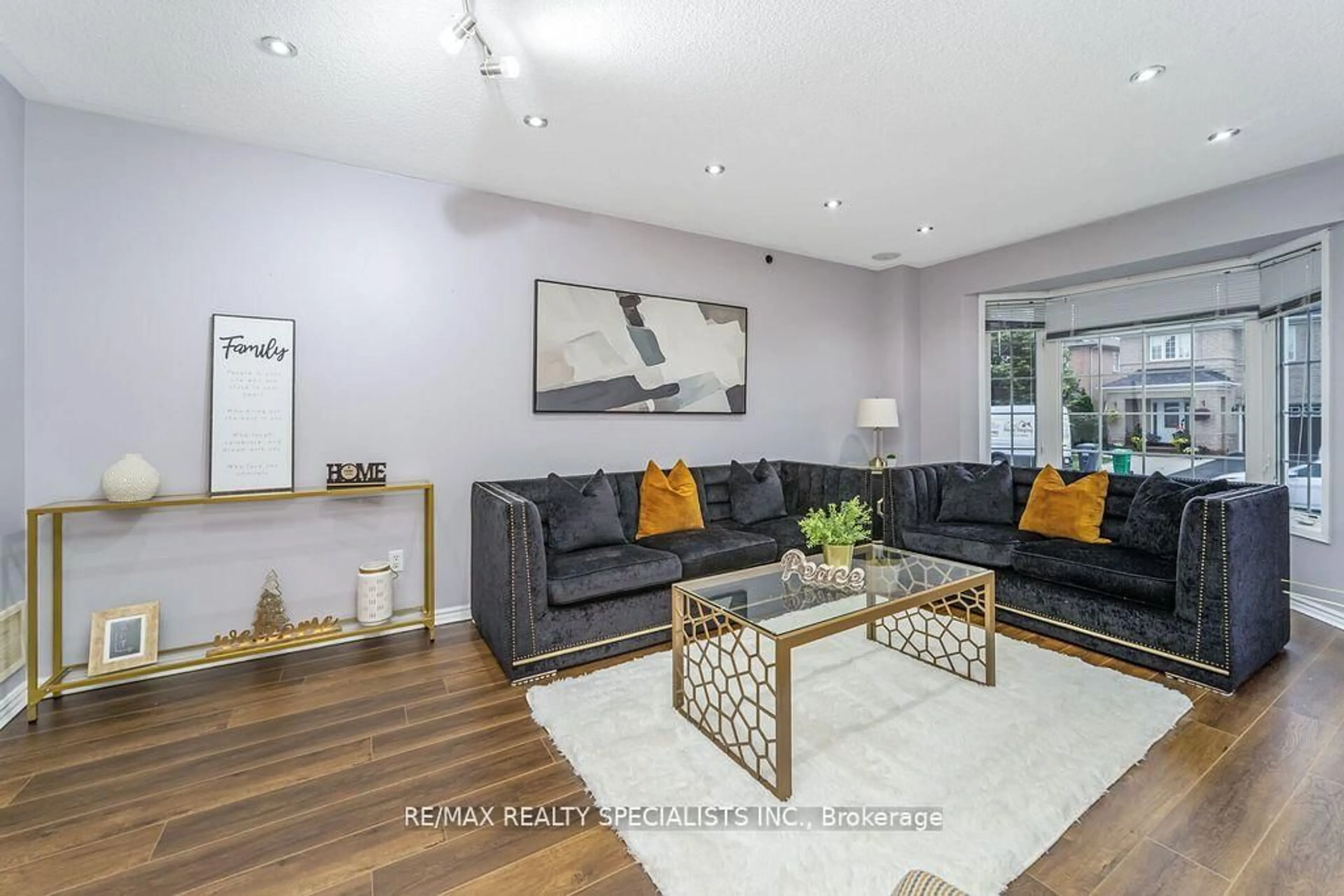 Living room with furniture, wood/laminate floor for 64 Botavia Downs Dr, Brampton Ontario L7A 3N8