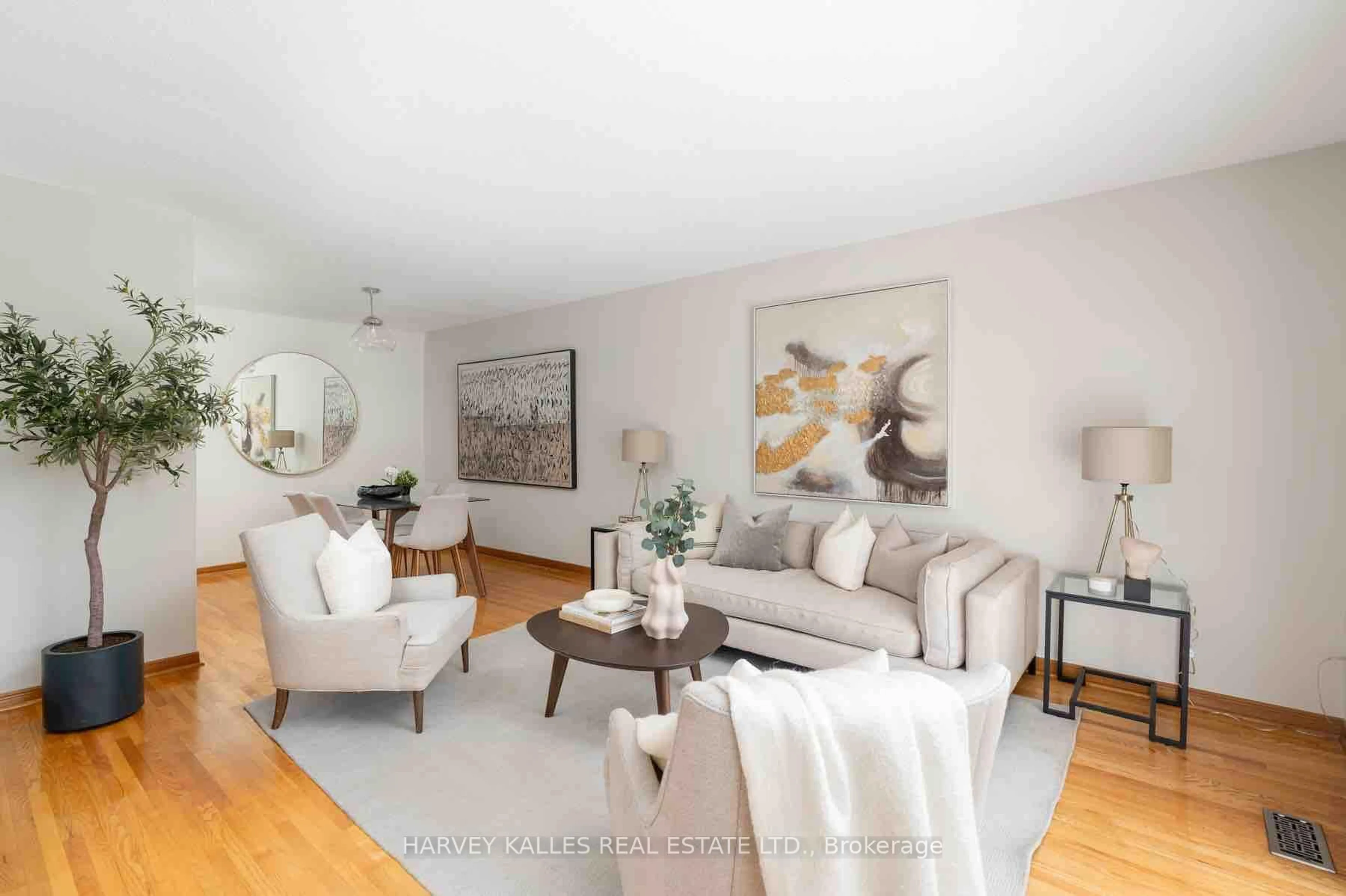 Living room with furniture, wood/laminate floor for 83 Clubhouse Crt, Toronto Ontario M3L 2L7