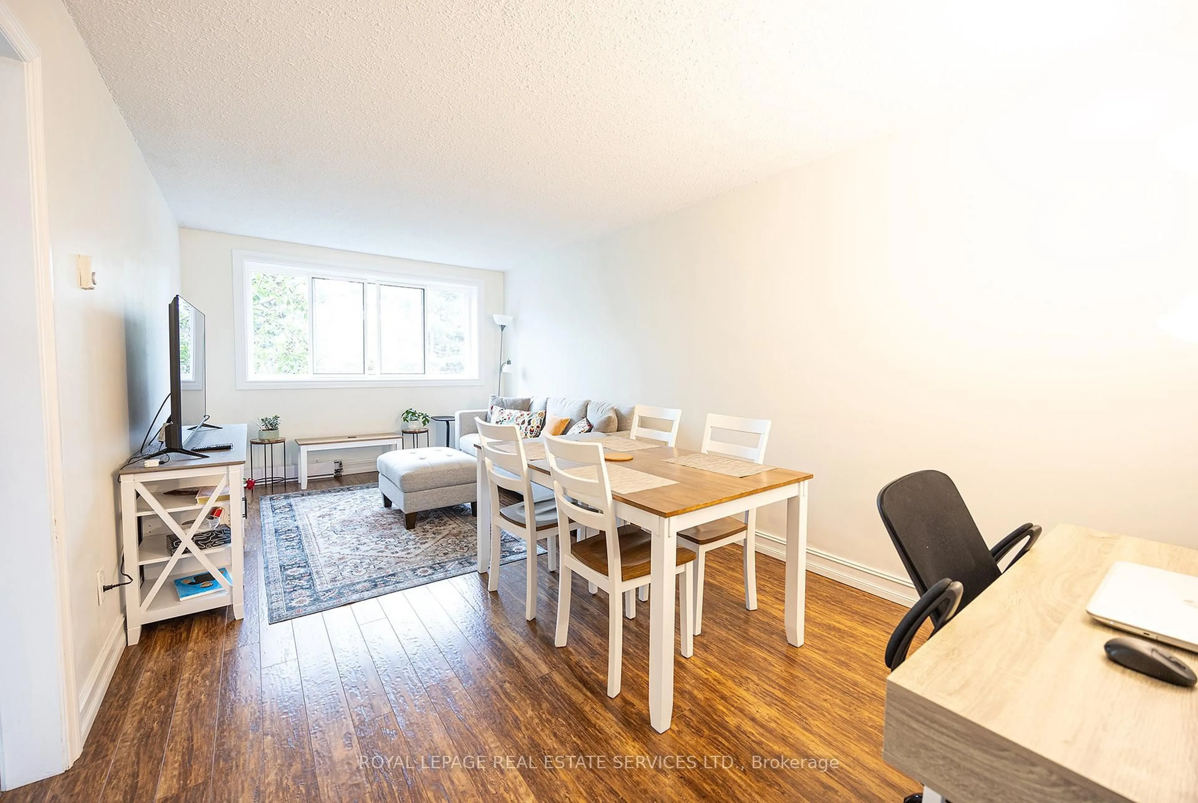 Living room with furniture, wood/laminate floor for 2170 Bromsgrove Rd #130, Mississauga Ontario L5J 4J2