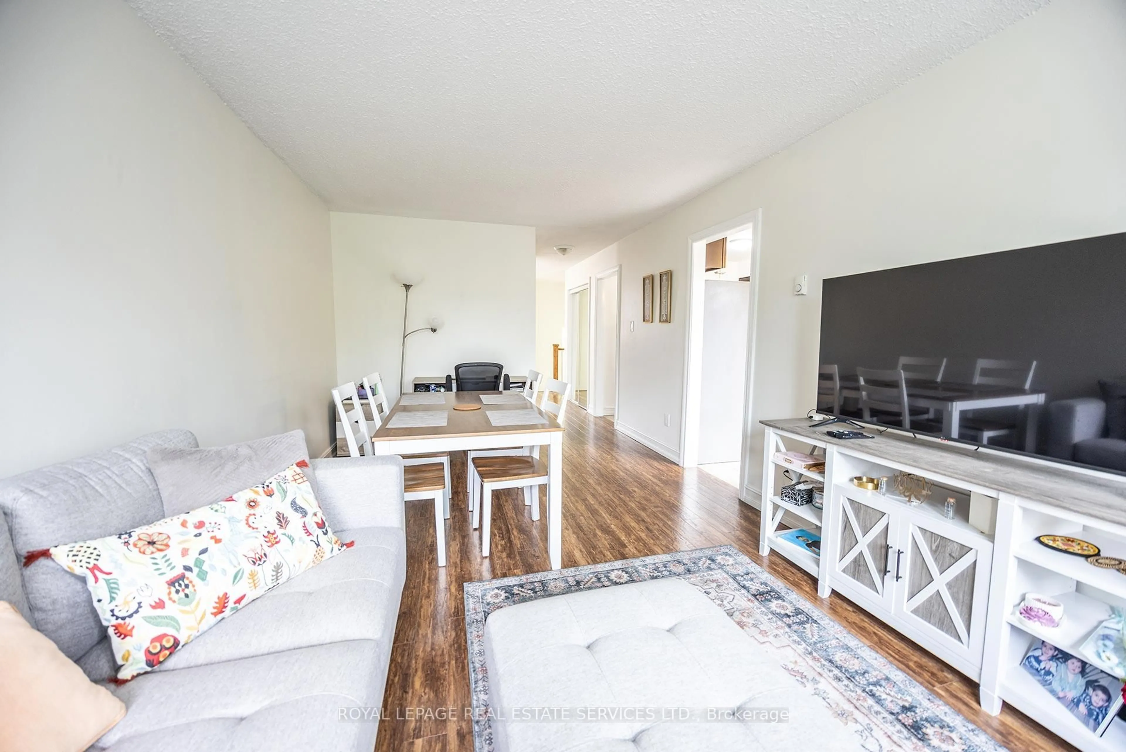 Living room with furniture, wood/laminate floor for 2170 Bromsgrove Rd #130, Mississauga Ontario L5J 4J2