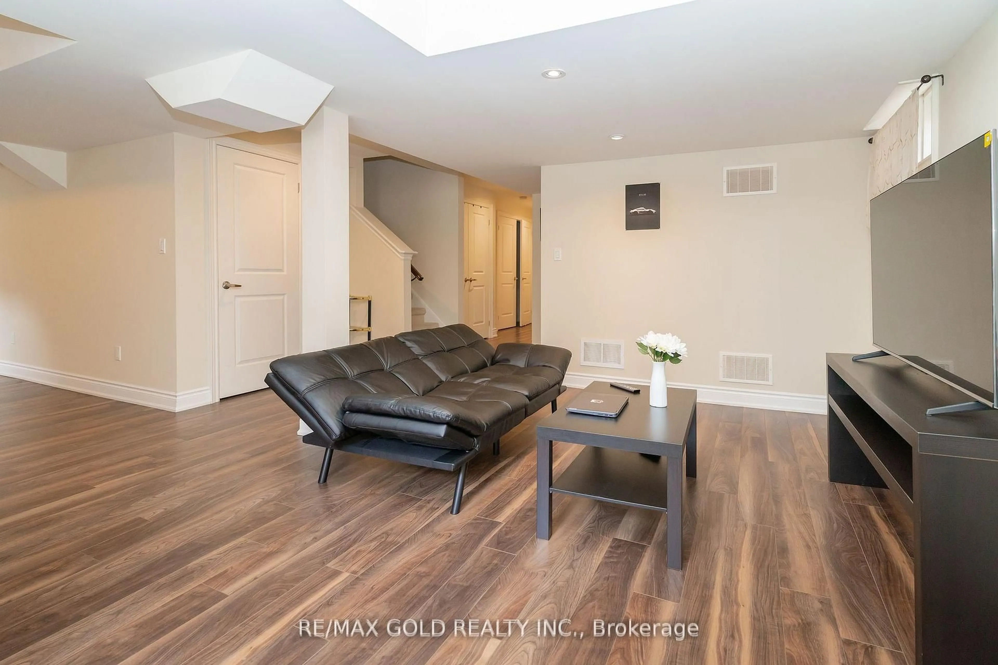 Living room with furniture, wood/laminate floor for 16 Palmvalley Dr, Brampton Ontario L6P 2V4