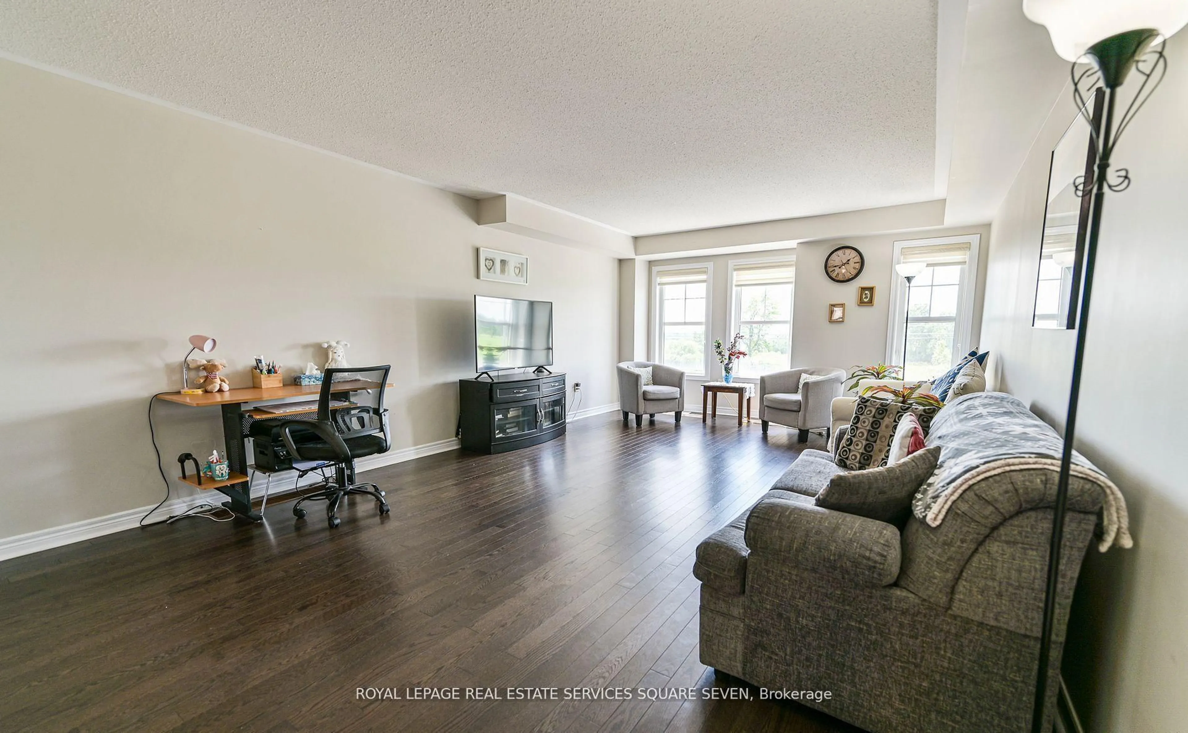 Living room with furniture, wood/laminate floor for 27 Pennycross Cres #3, Brampton Ontario L7A 4M1