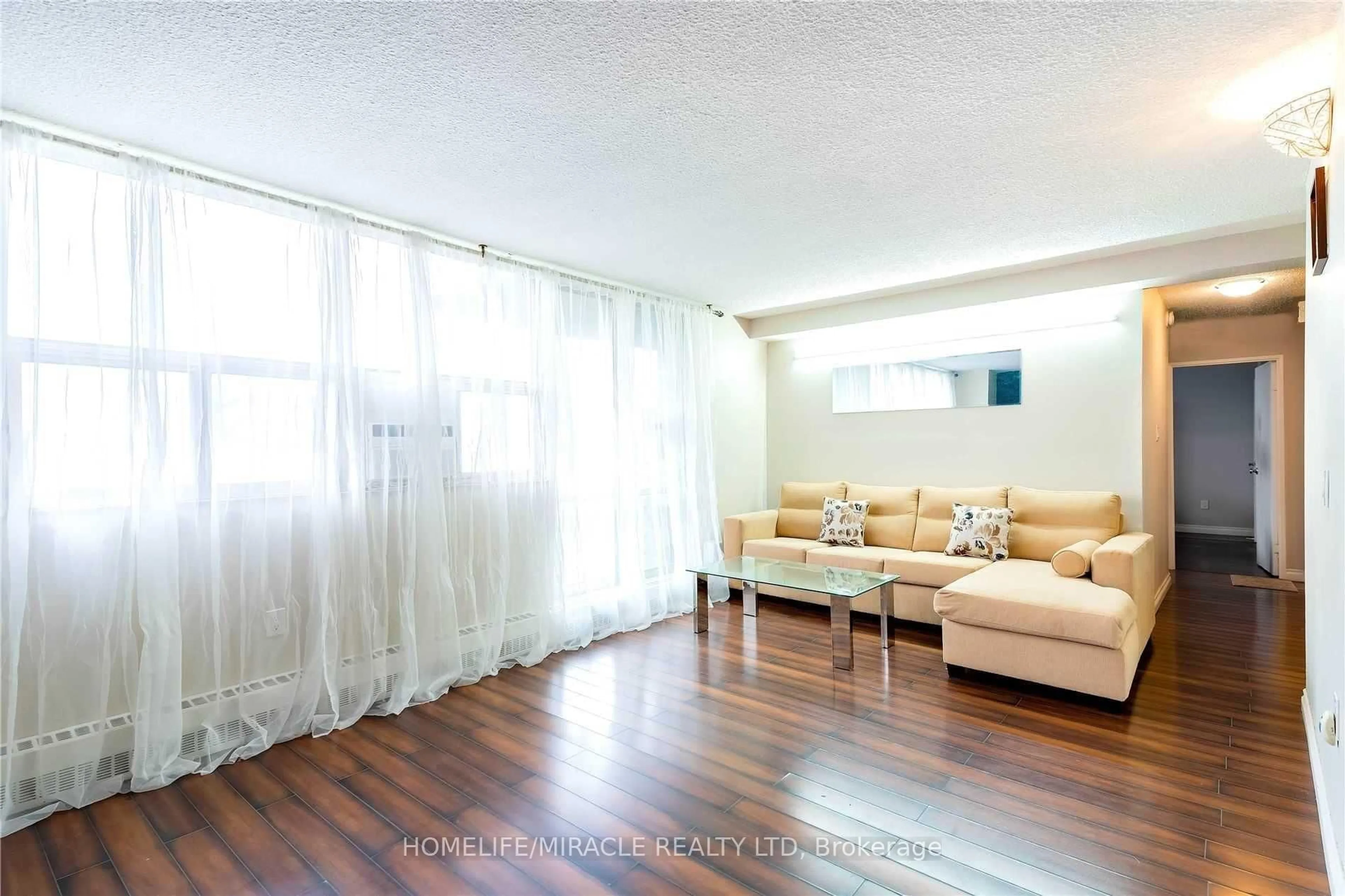 Living room with furniture, wood/laminate floor for 2645 Kipling Ave #404, Toronto Ontario M9V 3S6