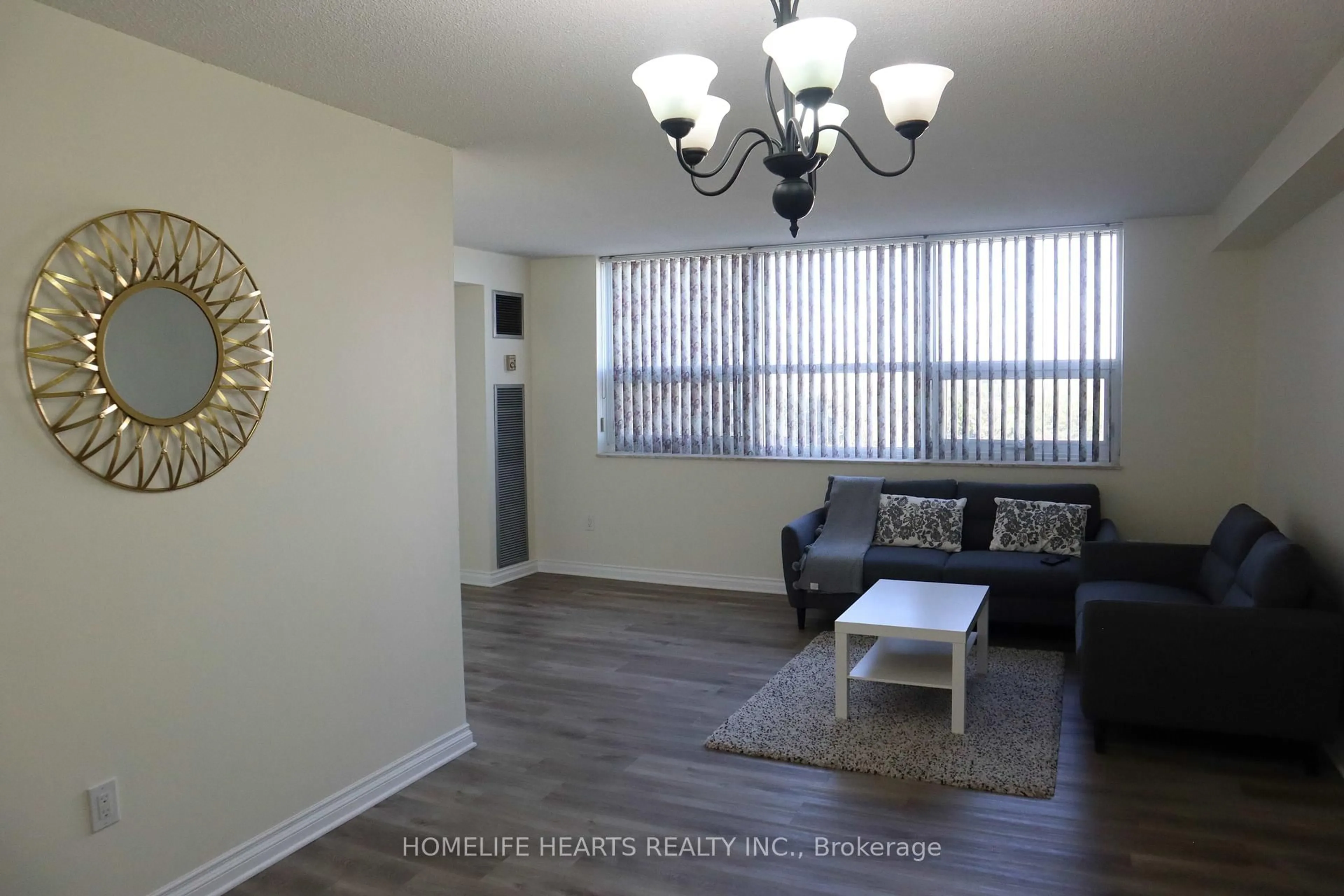 Living room with furniture, wood/laminate floor for 4 Lisa St #712, Brampton Ontario L6T 4B6