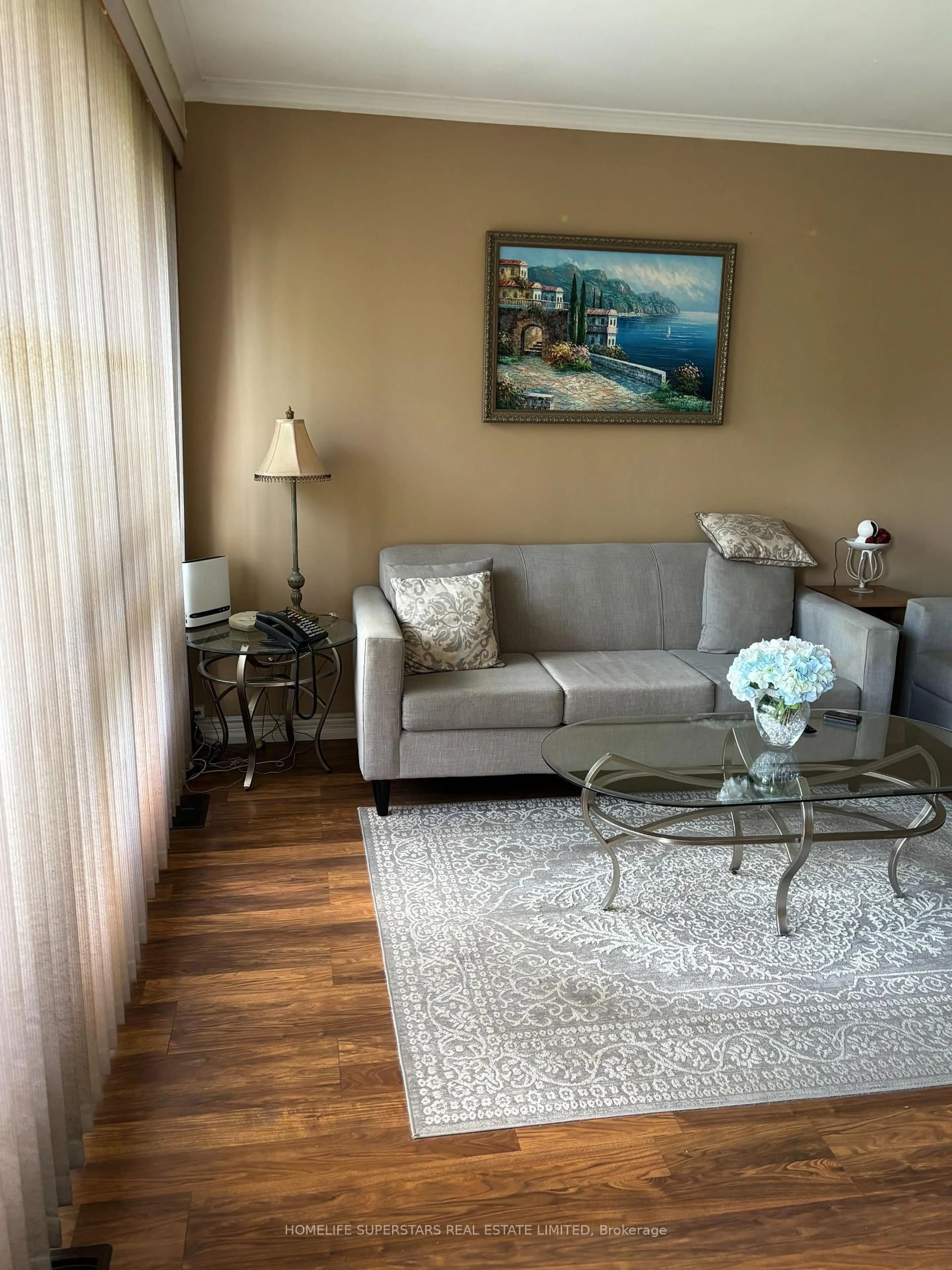 Living room with furniture, wood/laminate floor for 69 Thistle Down Blvd, Toronto Ontario M9V 1J1