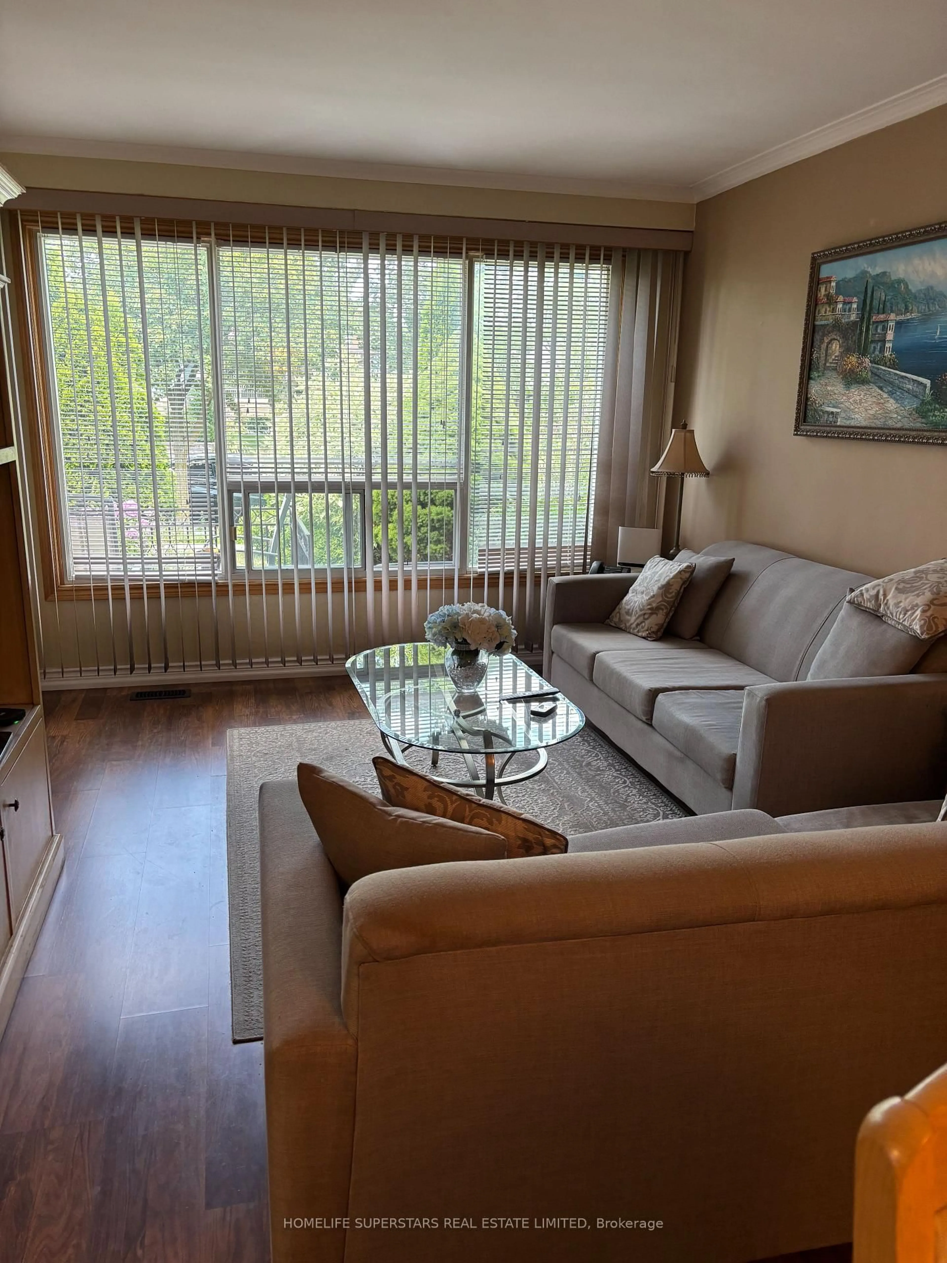 Living room with furniture, wood/laminate floor for 69 Thistle Down Blvd, Toronto Ontario M9V 1J1