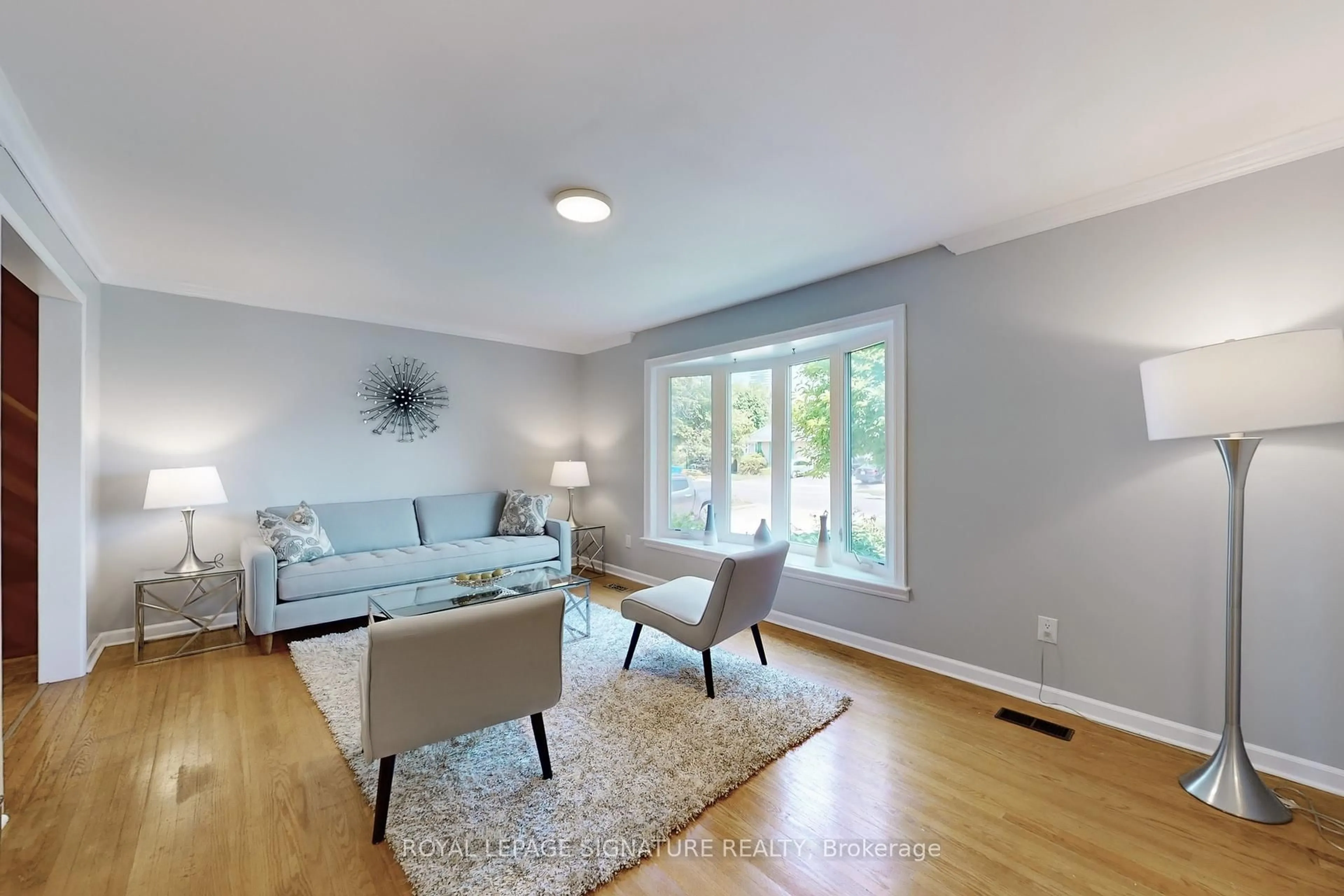Living room with furniture, wood/laminate floor for 61 Centre St, Brampton Ontario L6W 2X7