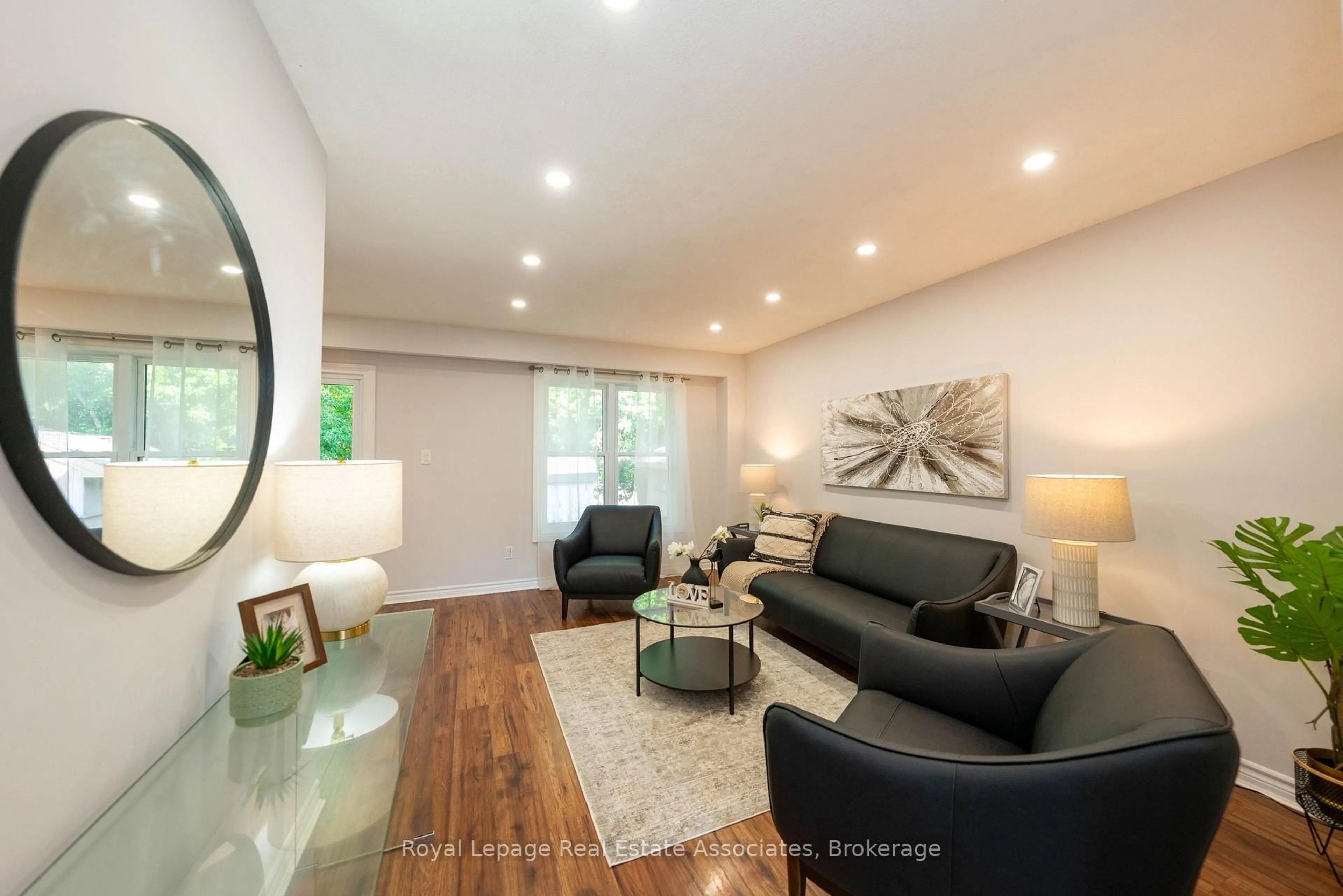 Living room with furniture, wood/laminate floor for 19 Burbank Cres, Orangeville Ontario L9W 3E6