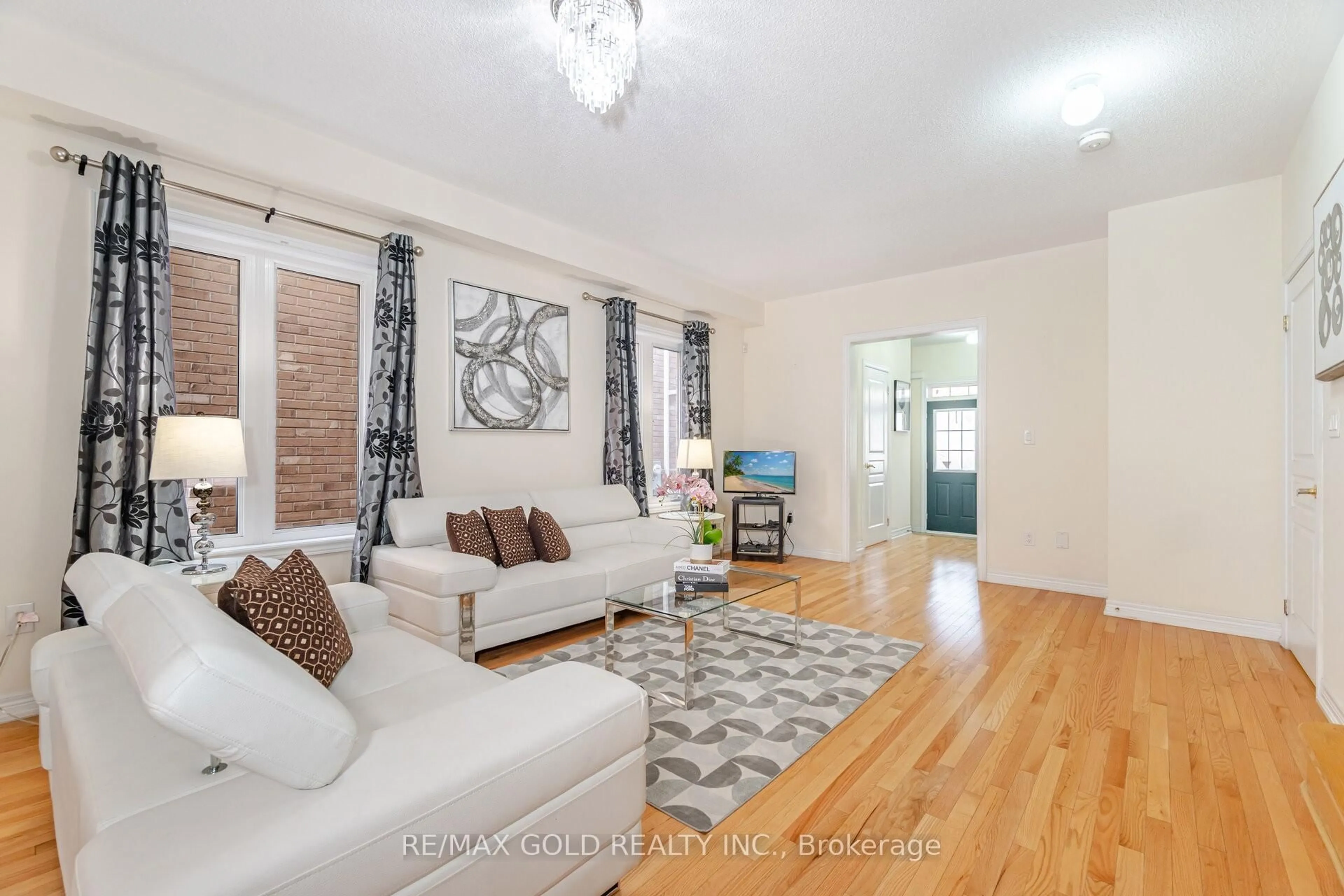 Living room with furniture, wood/laminate floor for 8 Washburn Rd, Brampton Ontario L6P 3V7