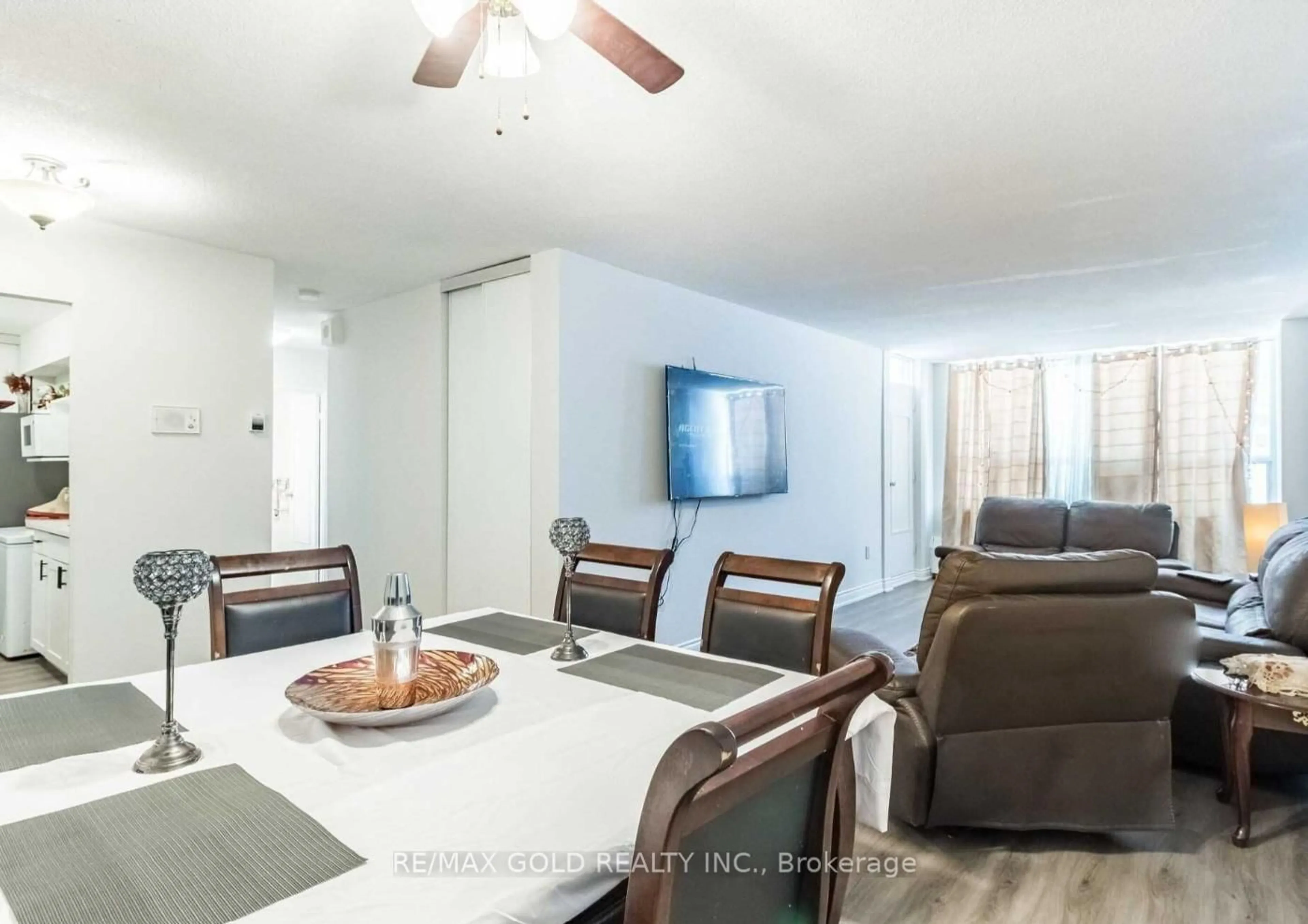 Living room with furniture, wood/laminate floor for 390 Dixon Rd #1603, Toronto Ontario M9R 1T4