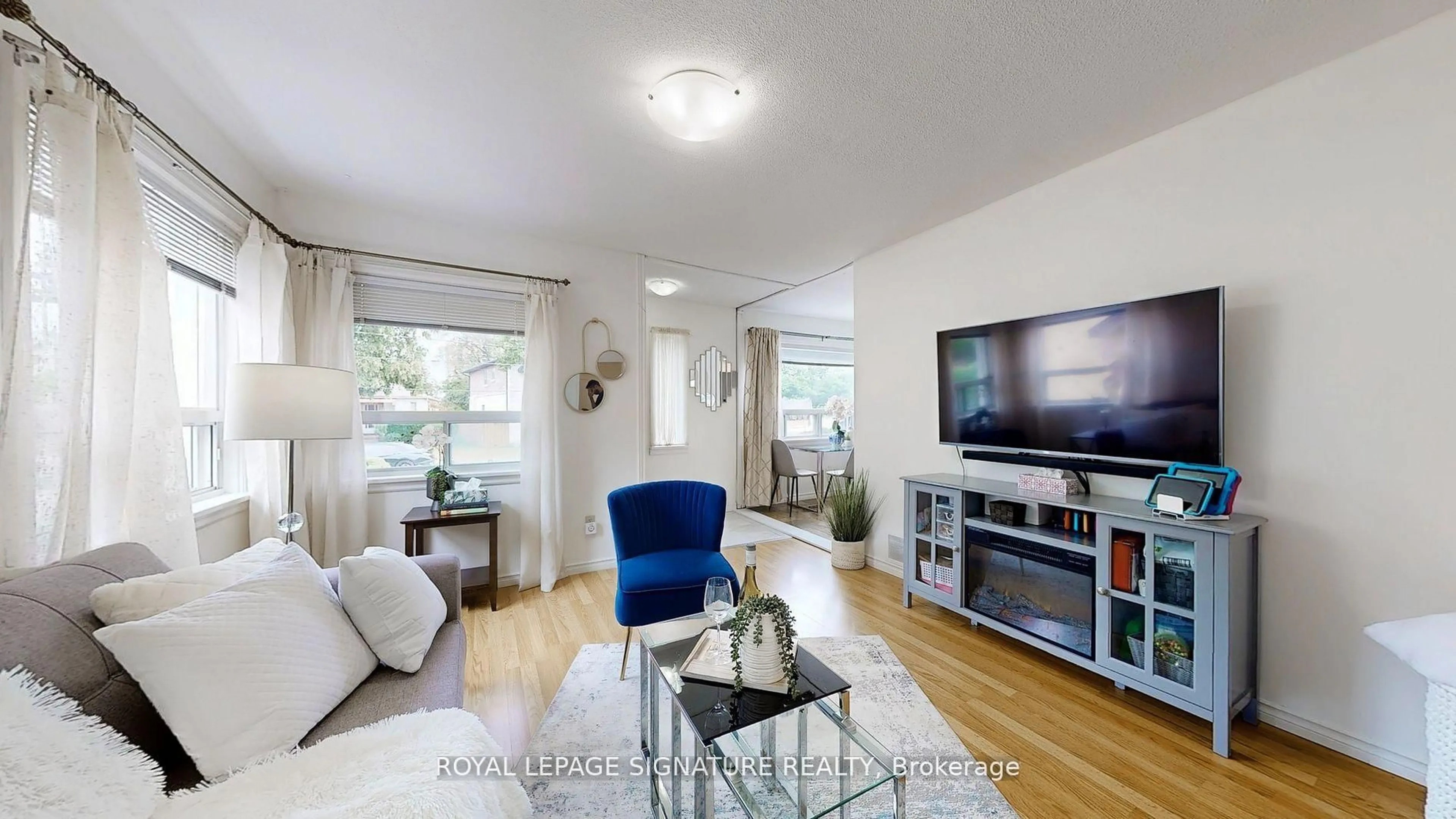 Living room with furniture, wood/laminate floor for 48 Acorn Ave, Toronto Ontario M9B 3P9