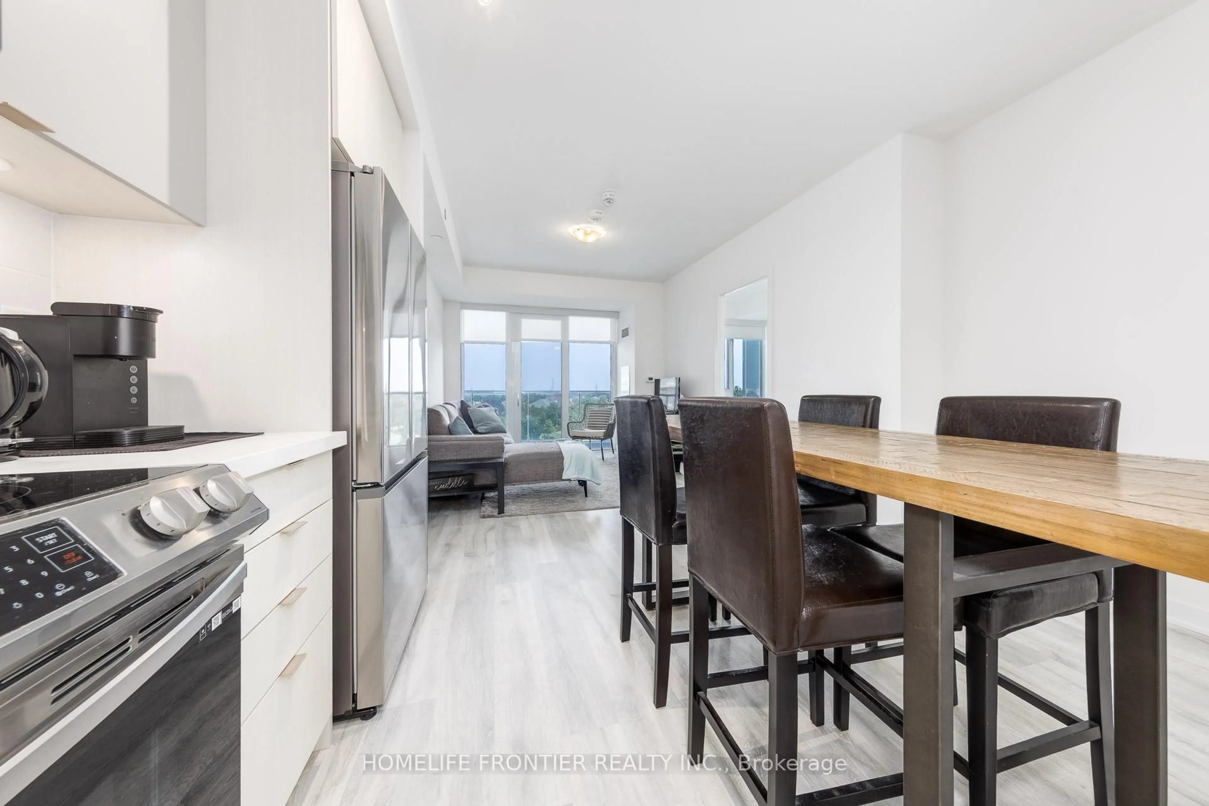 Open concept kitchen, wood/laminate floor for 4655 Metcalfe Ave #406, Mississauga Ontario L5M 0Z7