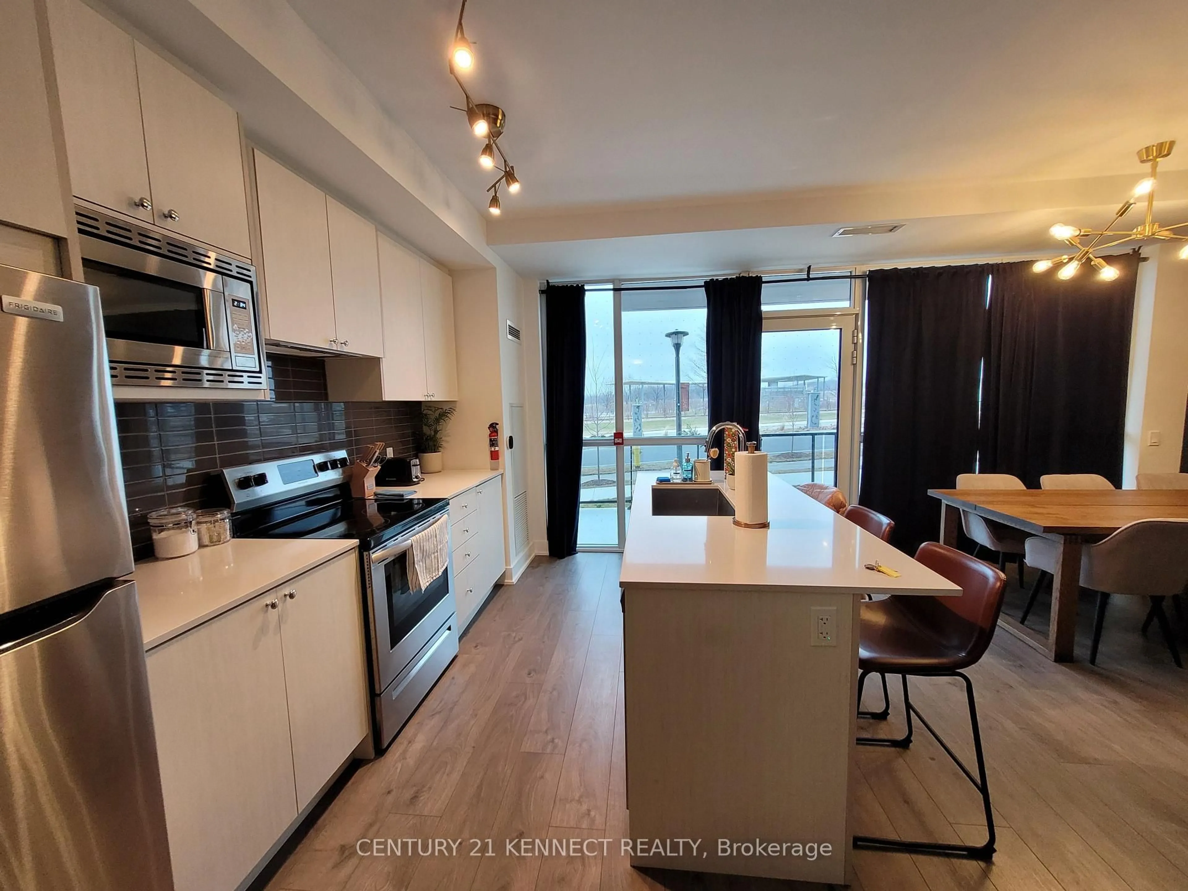 Open concept kitchen, wood/laminate floor for 60 George Butchart Dr #TH2, Toronto Ontario M3K 0E1