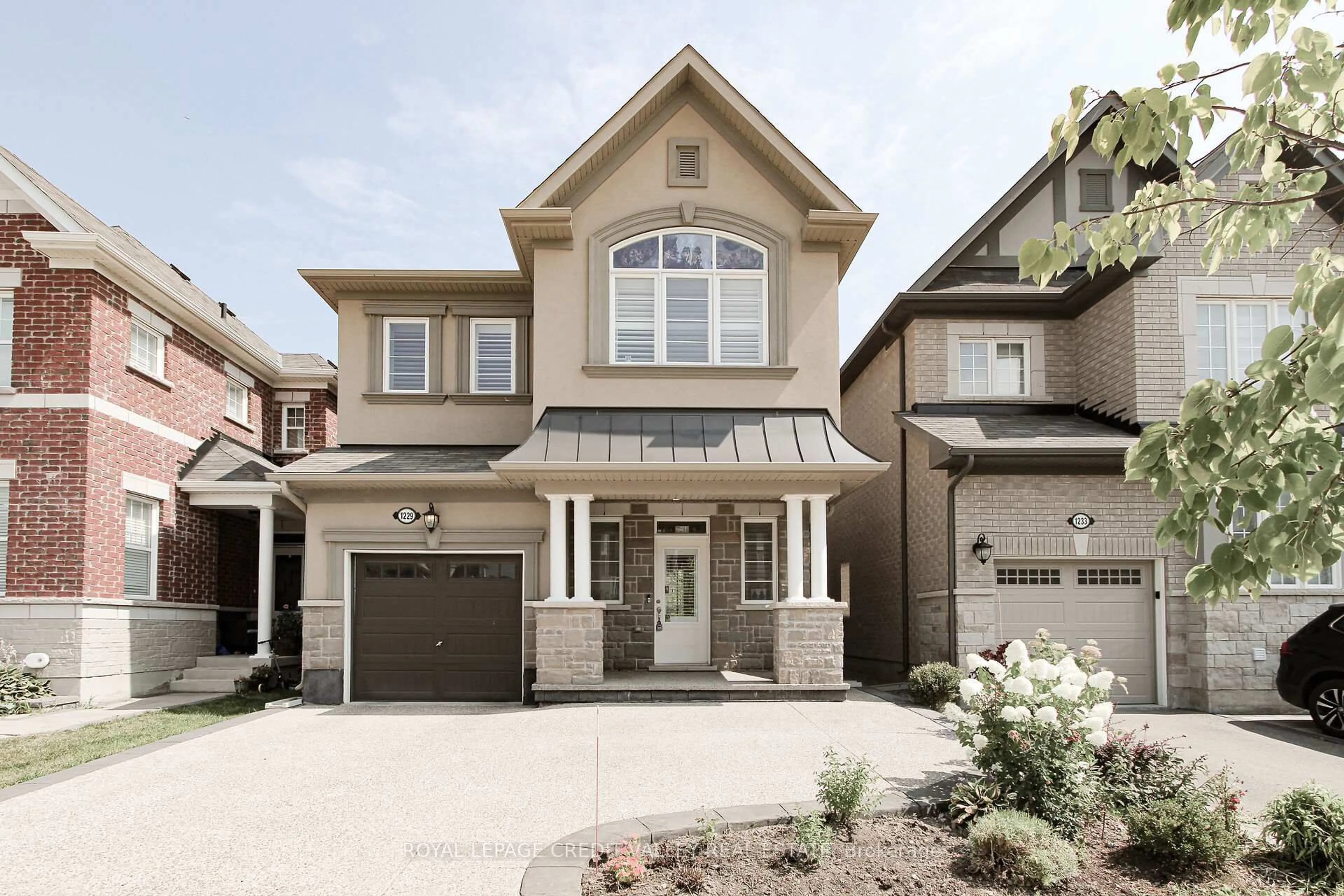Home with brick exterior material, street for 1229 Rose Way, Milton Ontario L9T 7E7