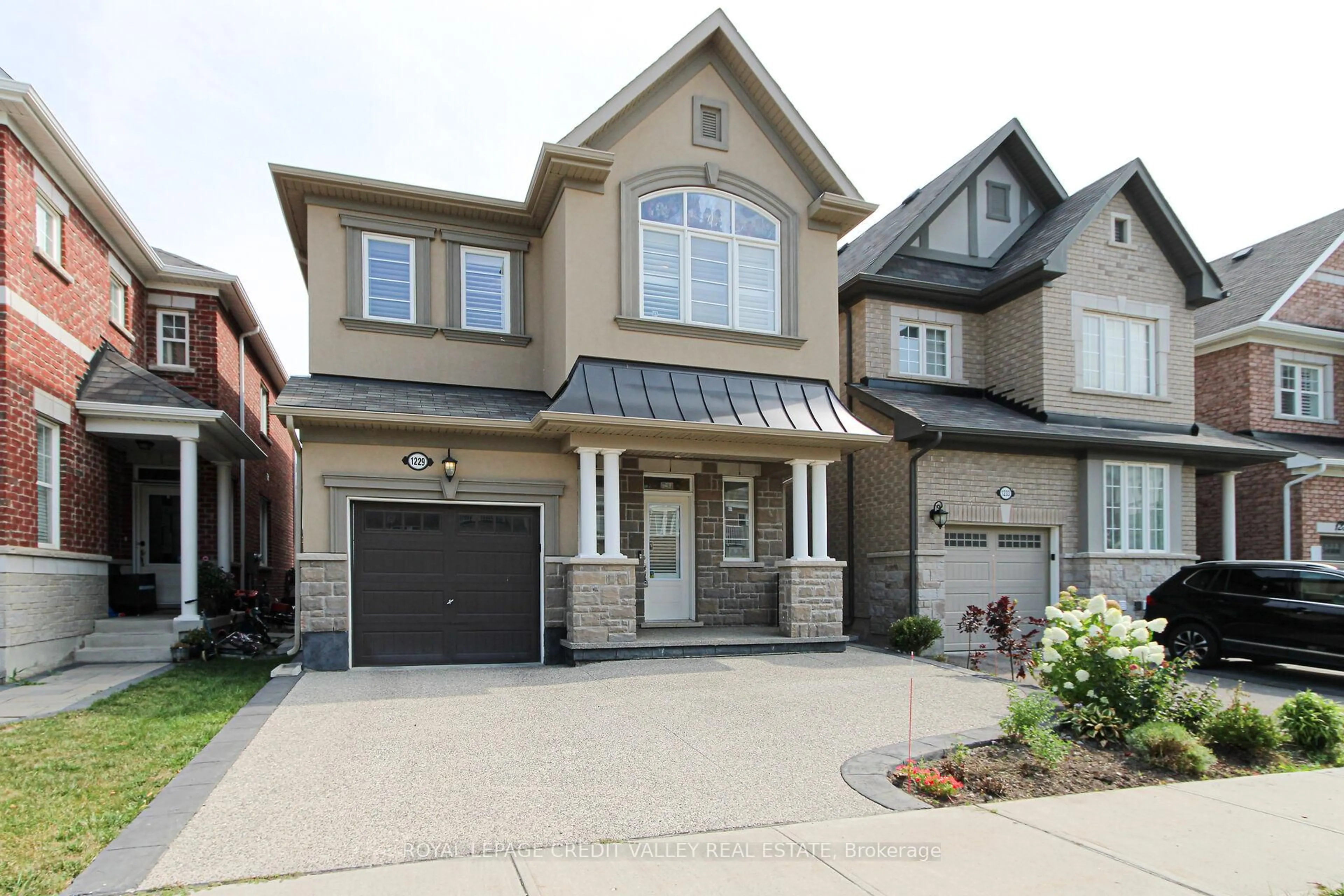 Home with brick exterior material, street for 1229 Rose Way, Milton Ontario L9T 7E7