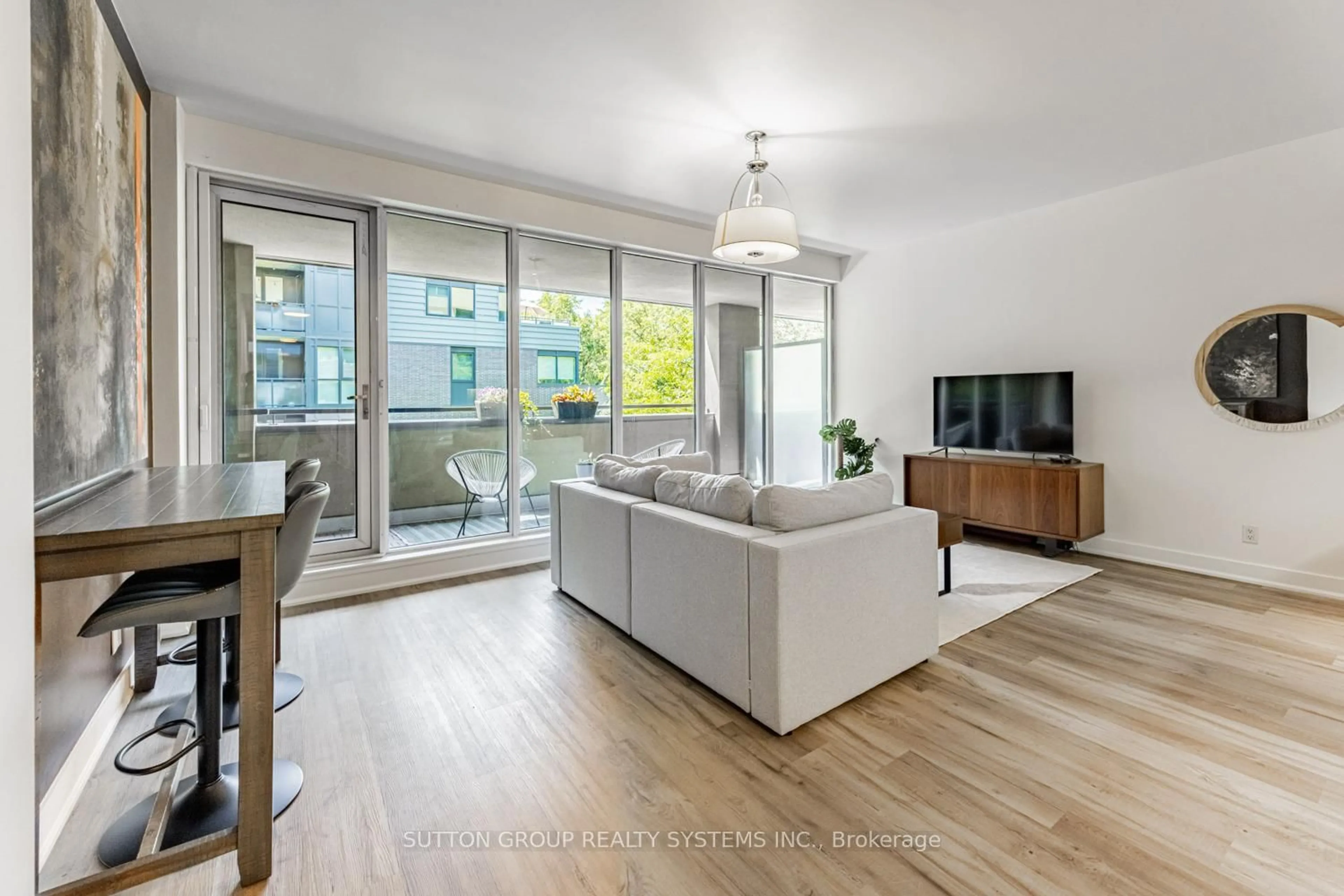 Living room with furniture, wood/laminate floor for 25 Ritchie Ave #310, Toronto Ontario M6R 2J6