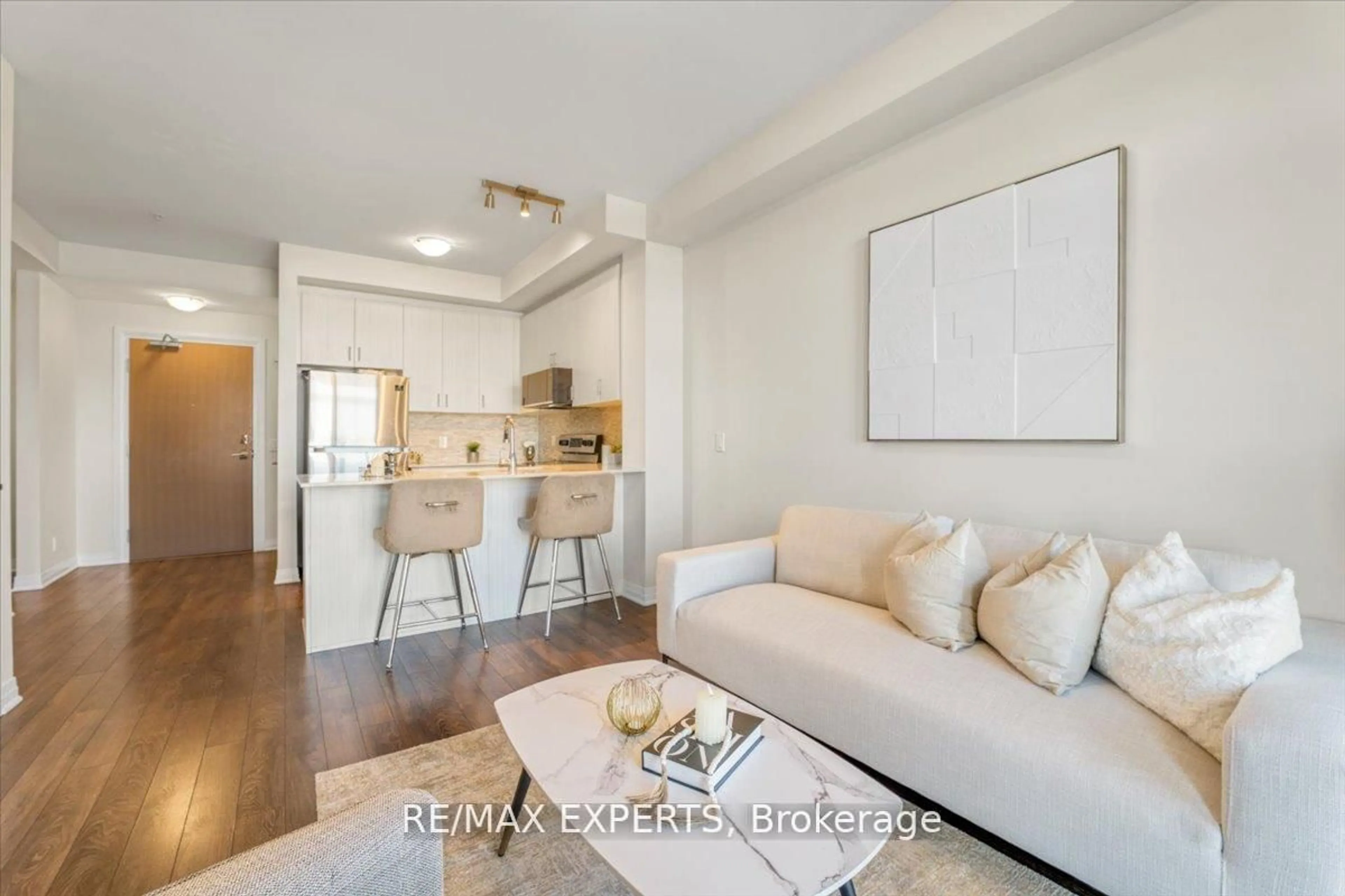 Living room with furniture, wood/laminate floor for 1105 Leger Way #527, Milton Ontario L9E 1K7