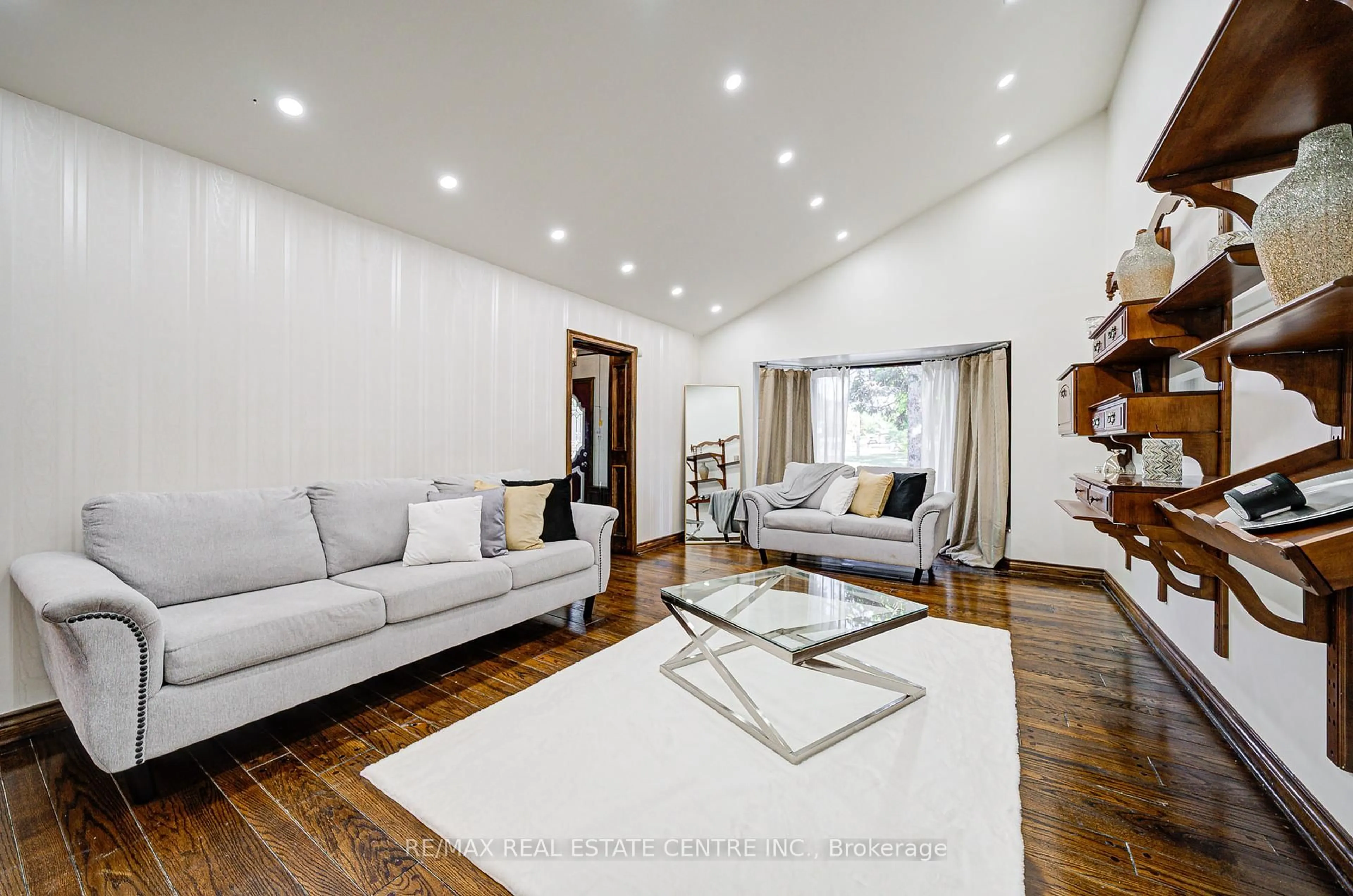 Living room with furniture, wood/laminate floor for 130 Cornwall Rd, Brampton Ontario L6W 1P3