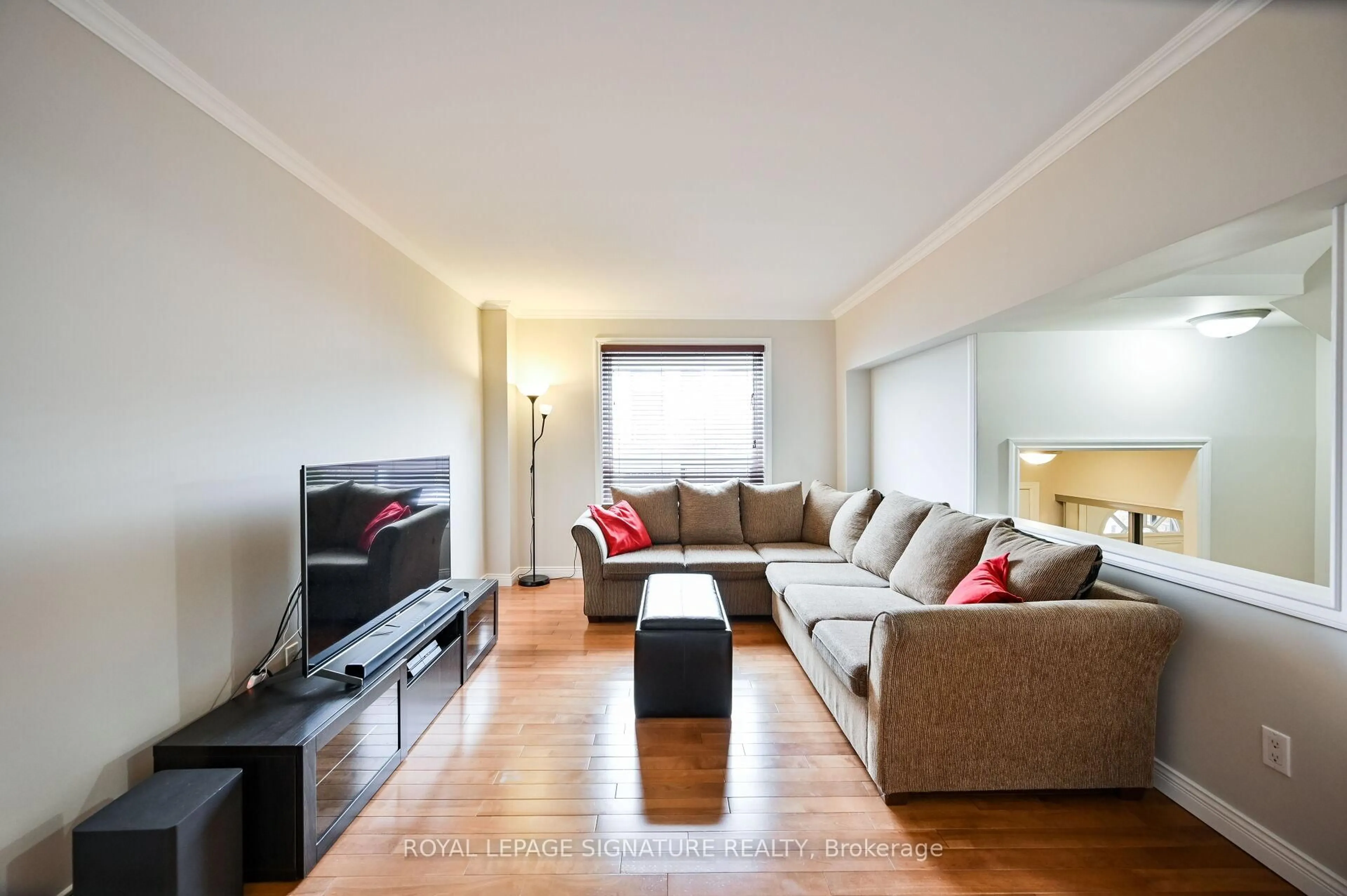 Living room with furniture, wood/laminate floor for 1221 Dundix Rd #101, Mississauga Ontario L4Y 3Y9
