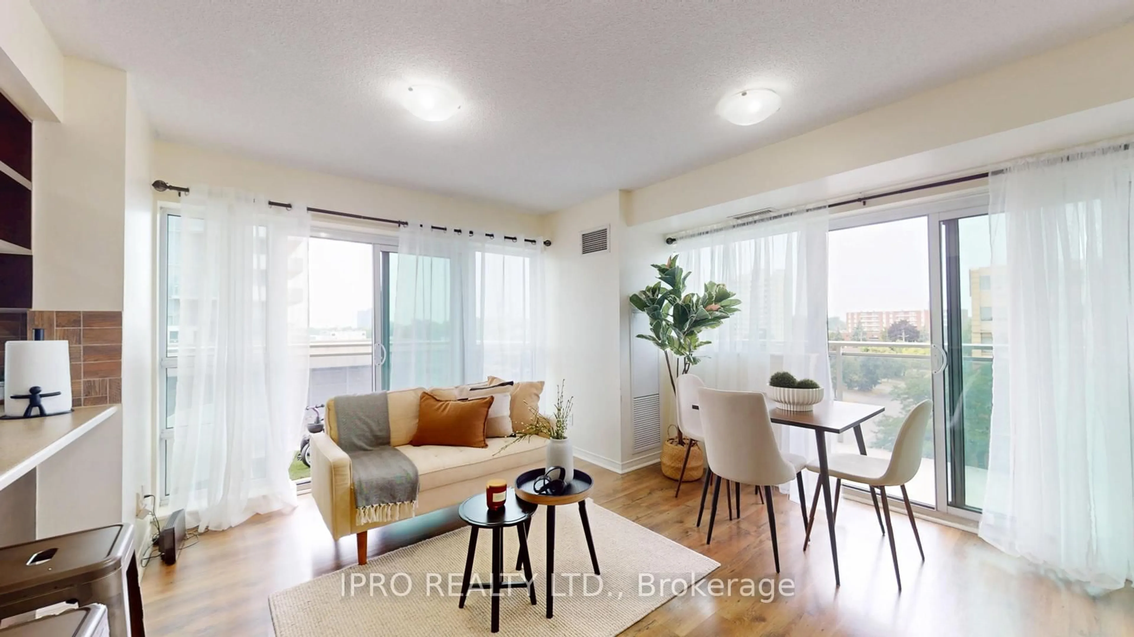 Living room with furniture, wood/laminate floor for 215 Queen St #509, Brampton Ontario L6Y 1M6