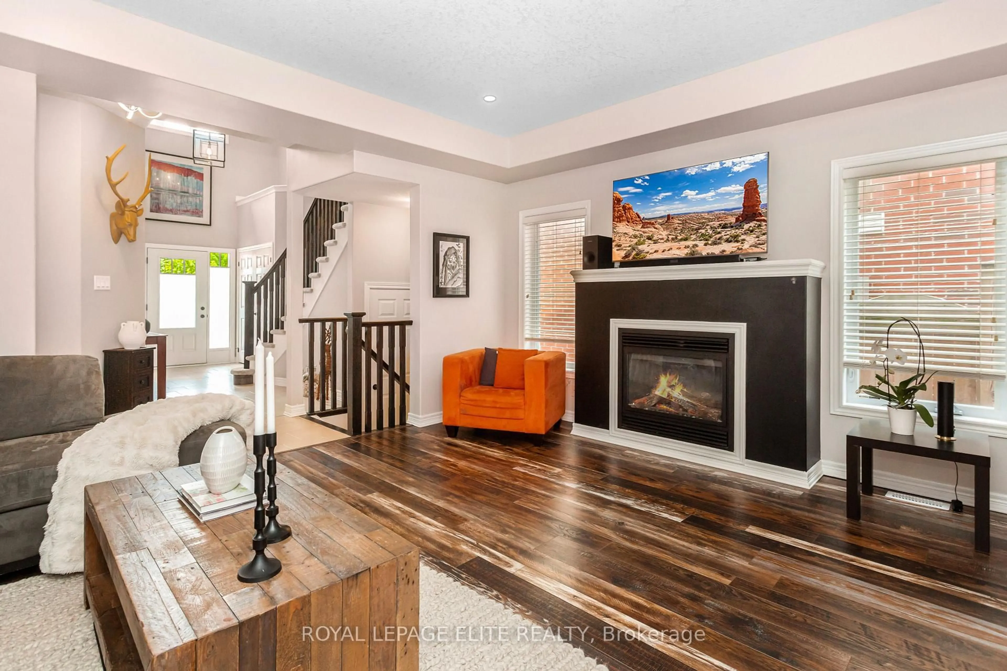Living room with furniture, wood/laminate floor for 49 PRESTON Dr, Orangeville Ontario L9W 4K3