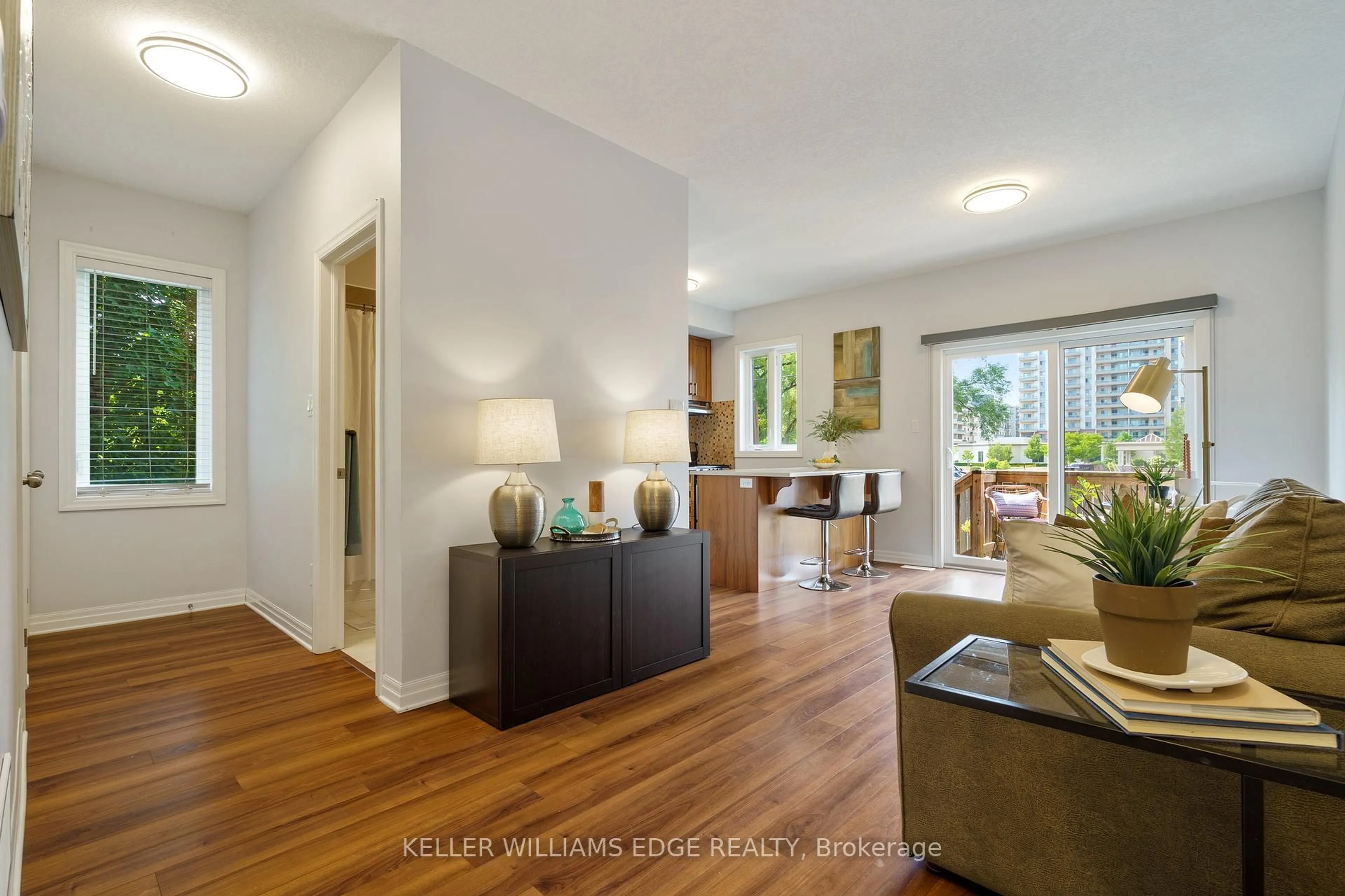 Living room with furniture, wood/laminate floor for 70 Plains Rd #29, Burlington Ontario L7T 0B6