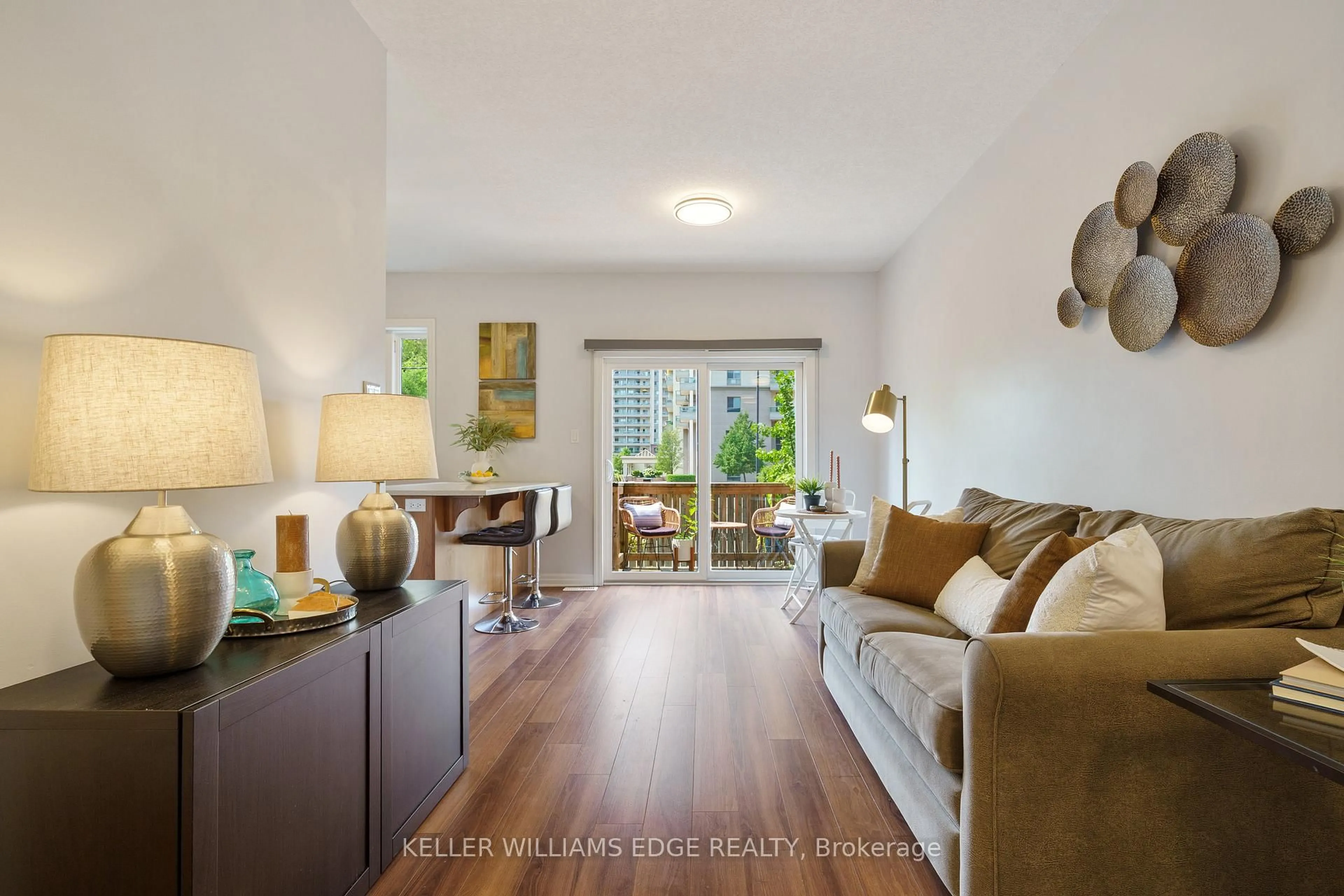 Living room with furniture, wood/laminate floor for 70 Plains Rd #29, Burlington Ontario L7T 0B6