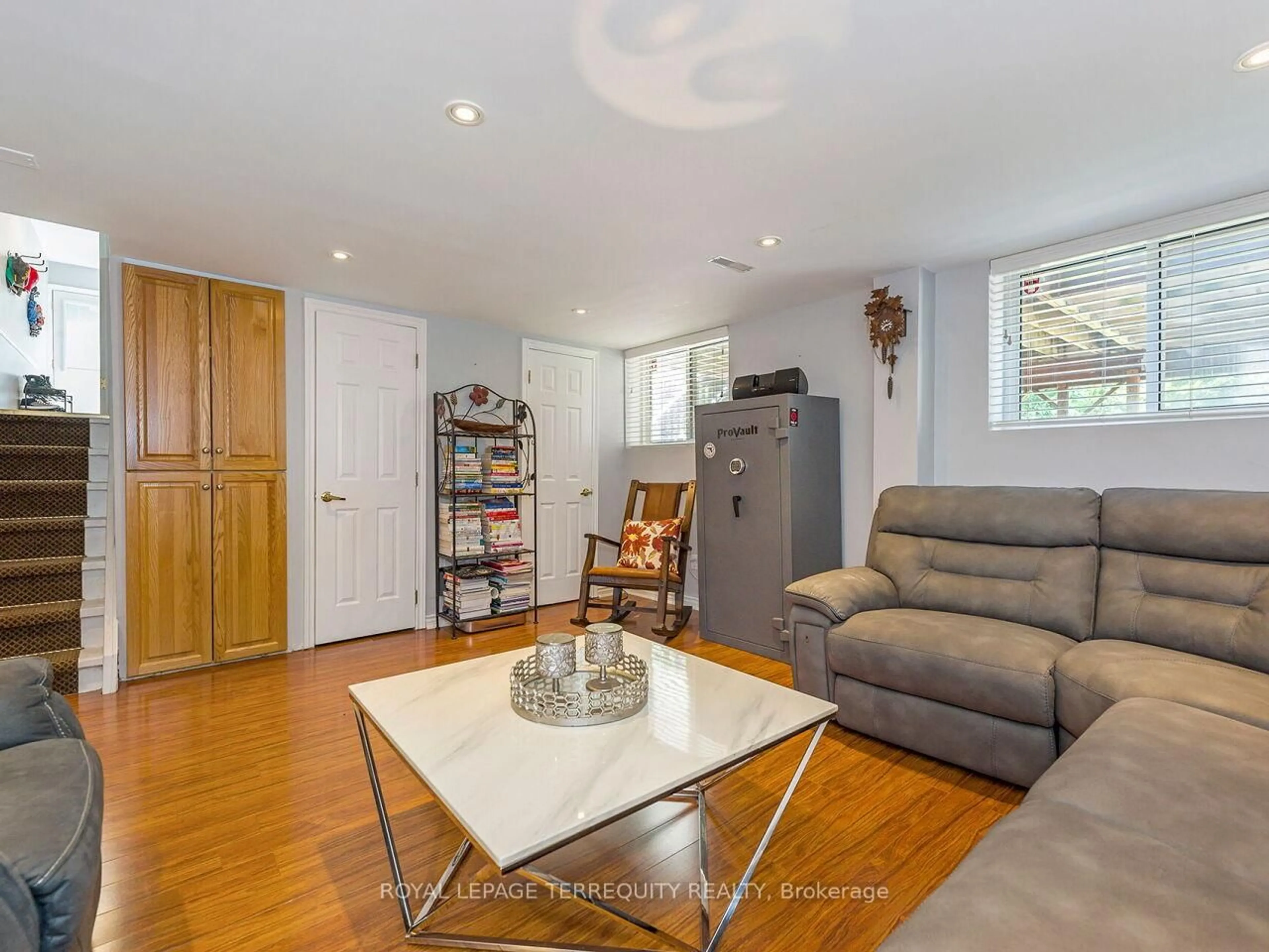 Living room with furniture, wood/laminate floor for 21 Pylon Pl, Toronto Ontario M9W 2P3