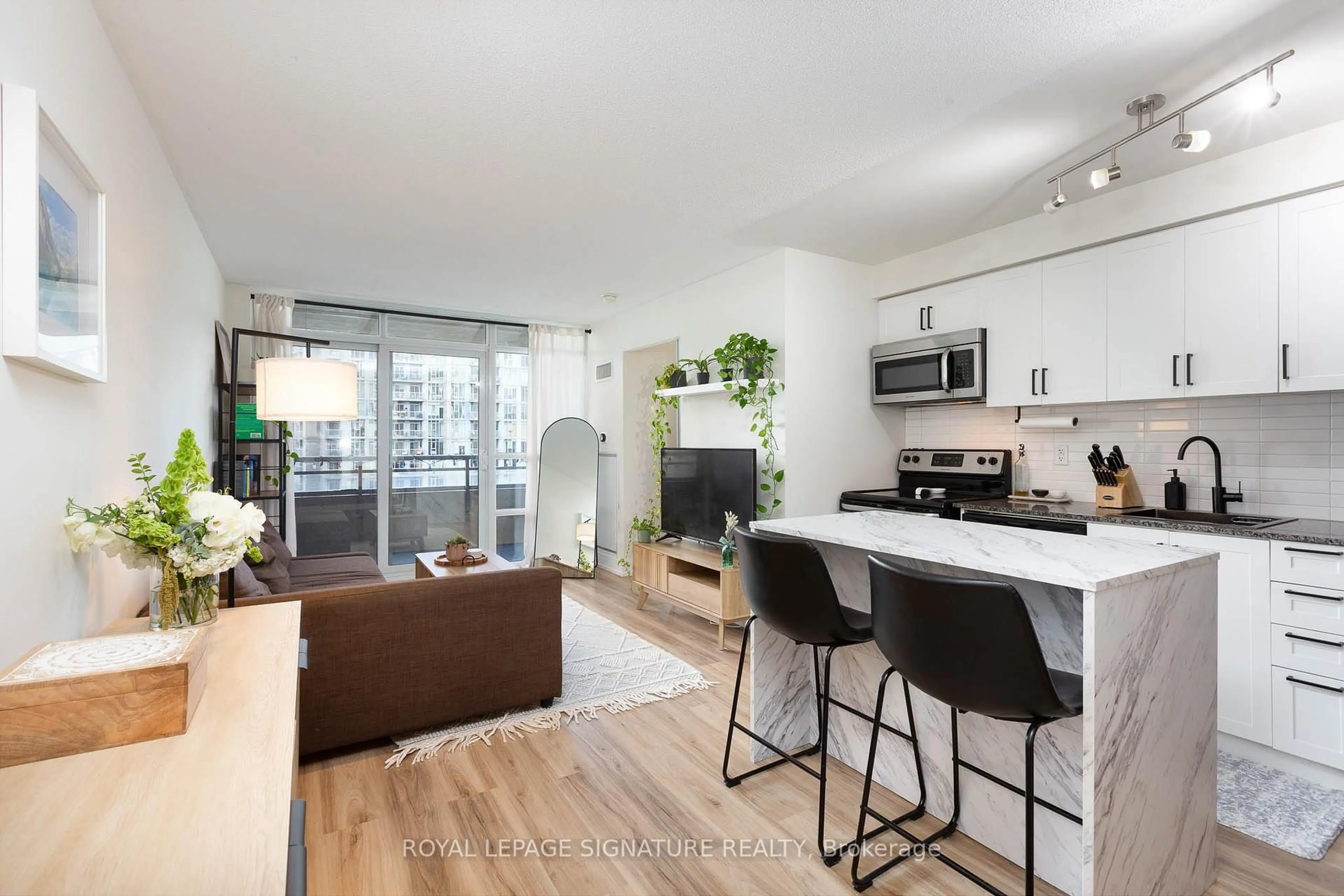 Open concept kitchen, wood/laminate floor for 38 Joe Shuster Way #1323, Toronto Ontario M6K 0A5