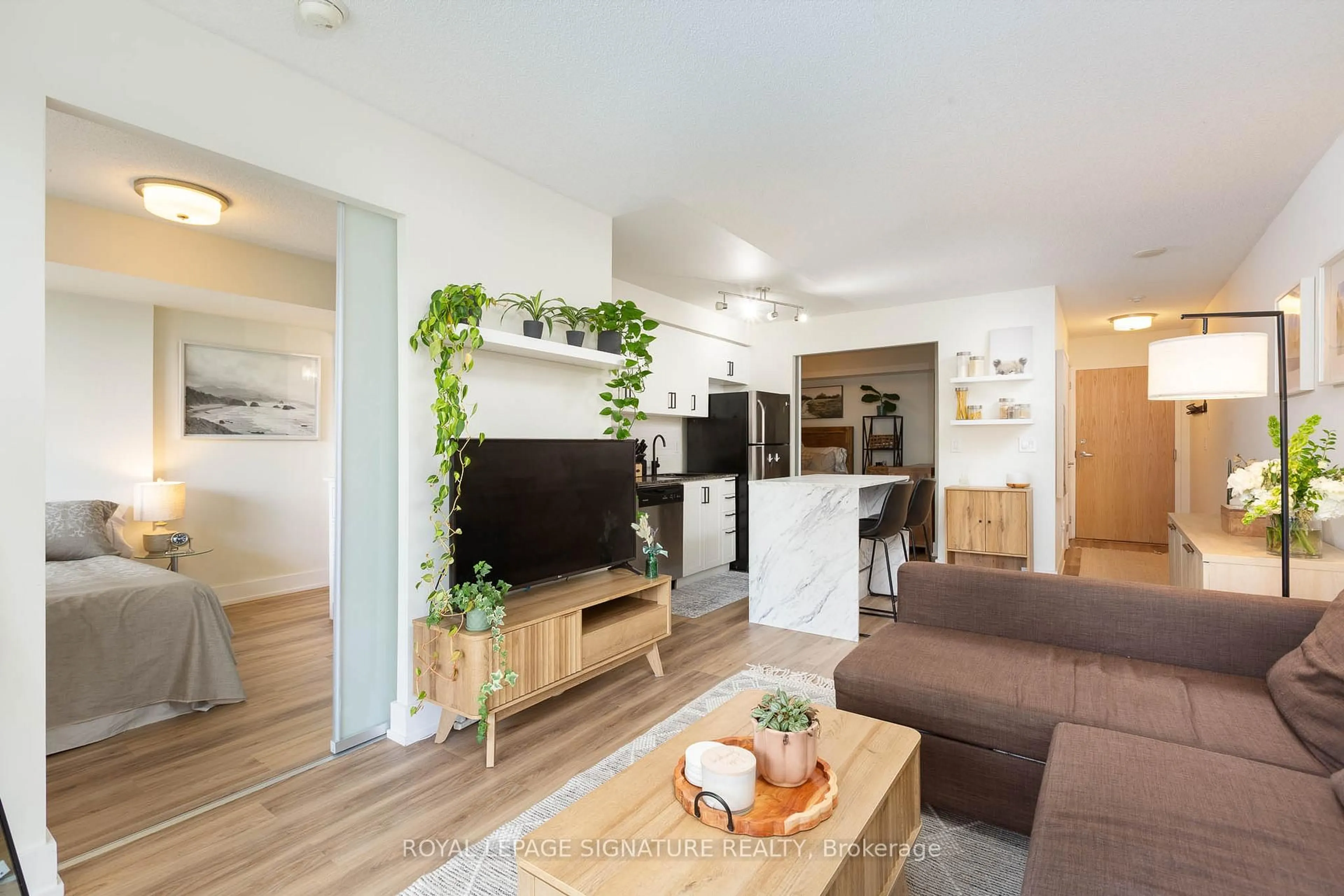 Living room with furniture, wood/laminate floor for 38 Joe Shuster Way #1323, Toronto Ontario M6K 0A5