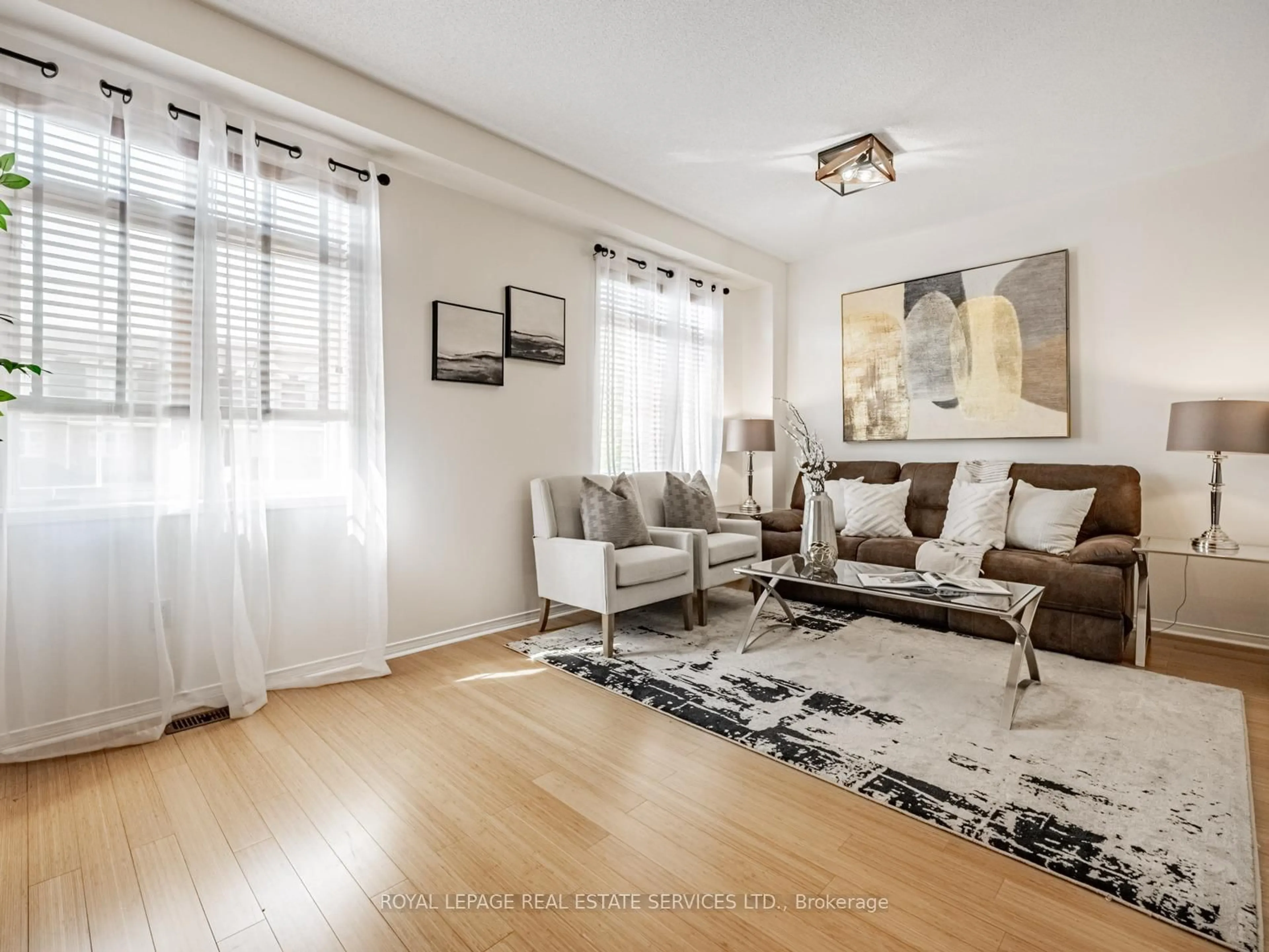 Living room with furniture, wood/laminate floor for 3370 Southwick St, Mississauga Ontario L5M 7L5