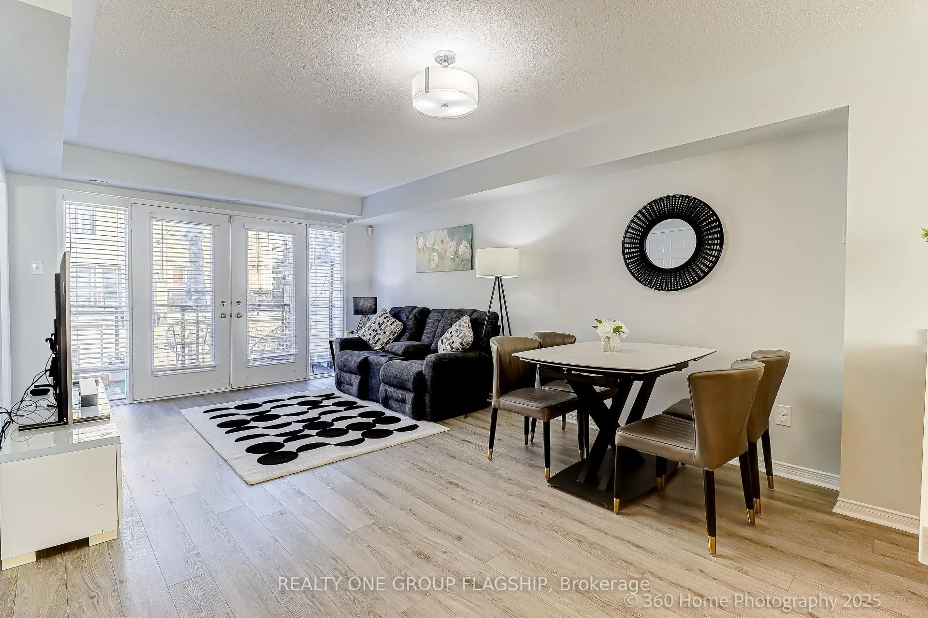 Living room with furniture, wood/laminate floor for 3050 Erin Centre Blvd #114, Mississauga Ontario L5M 0P5