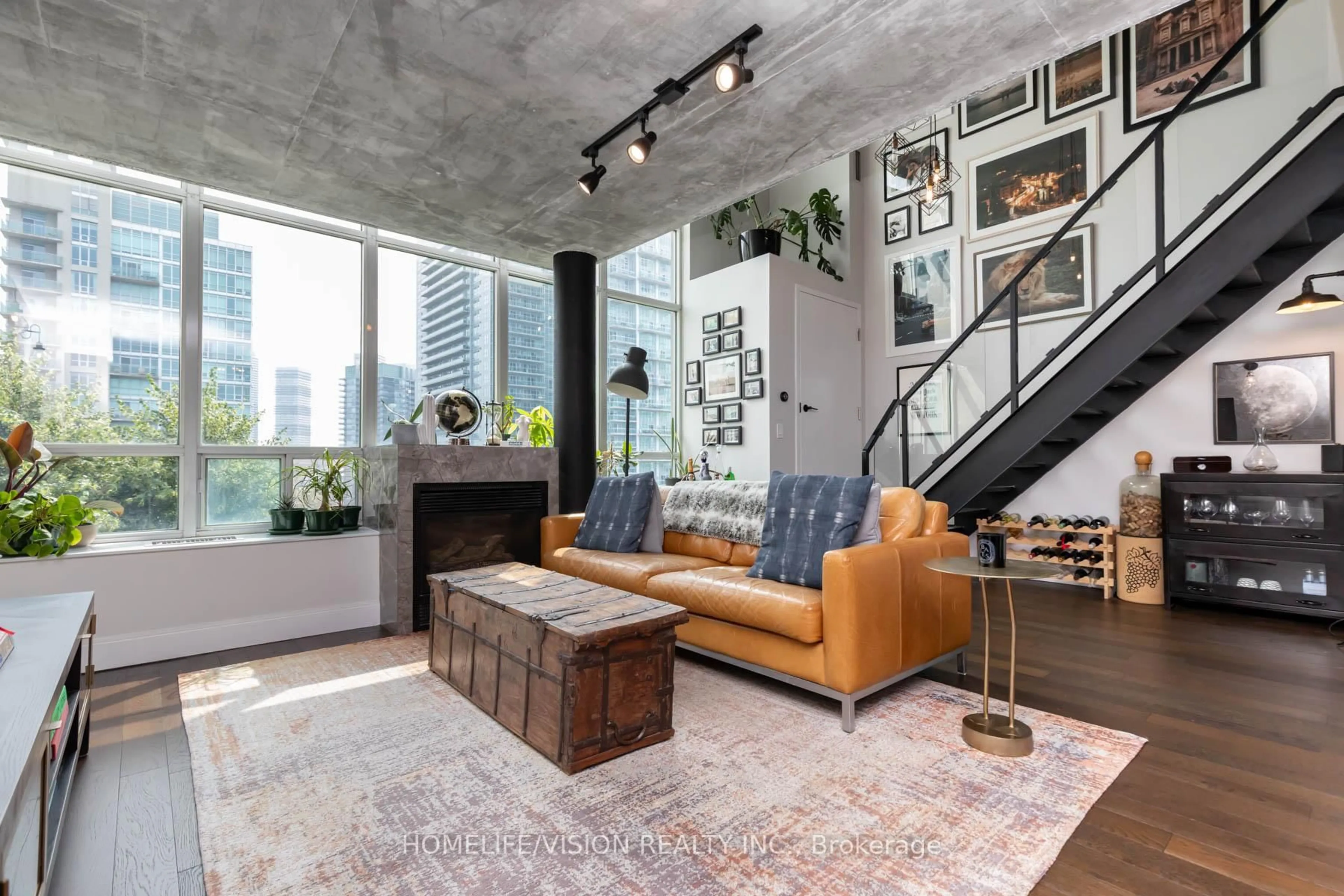 Living room with furniture, cement floor for 250 Manitoba St #704, Toronto Ontario M8Y 4G8
