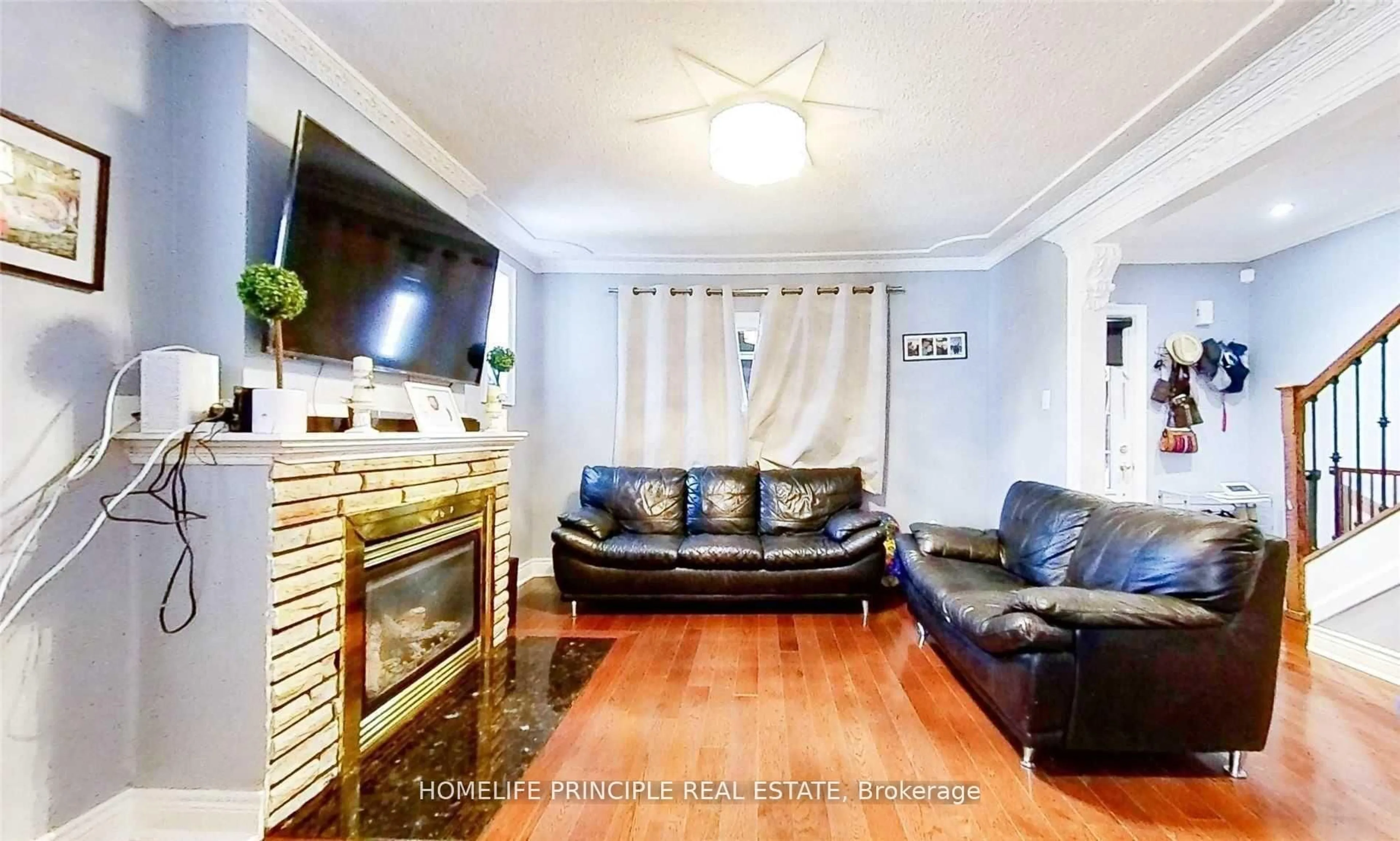 Living room with furniture, wood/laminate floor for 1610 Weston Rd, Toronto Ontario M9N 1T9