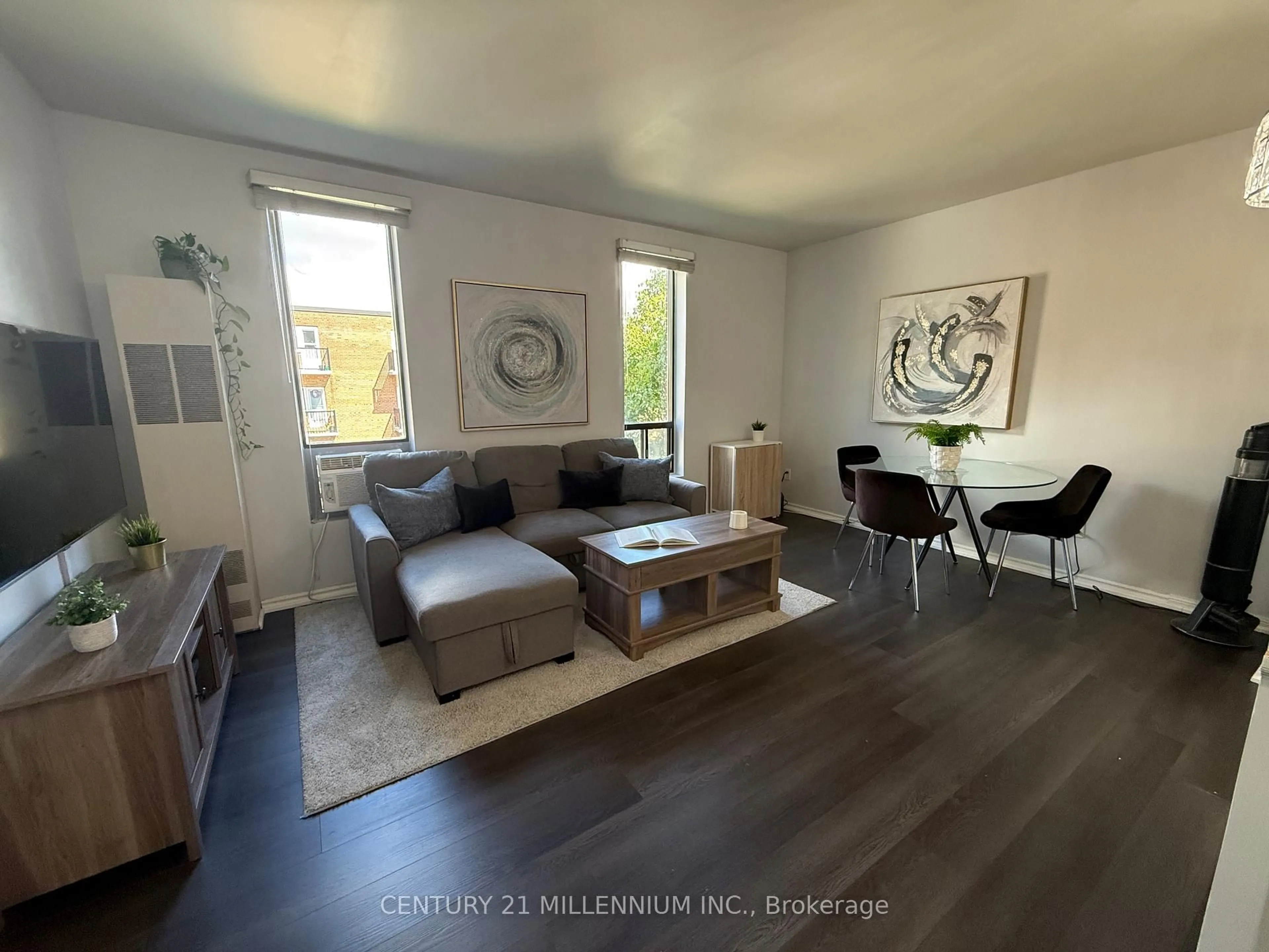 Living room with furniture, wood/laminate floor for 70 First St #206, Orangeville Ontario L9W 2E5