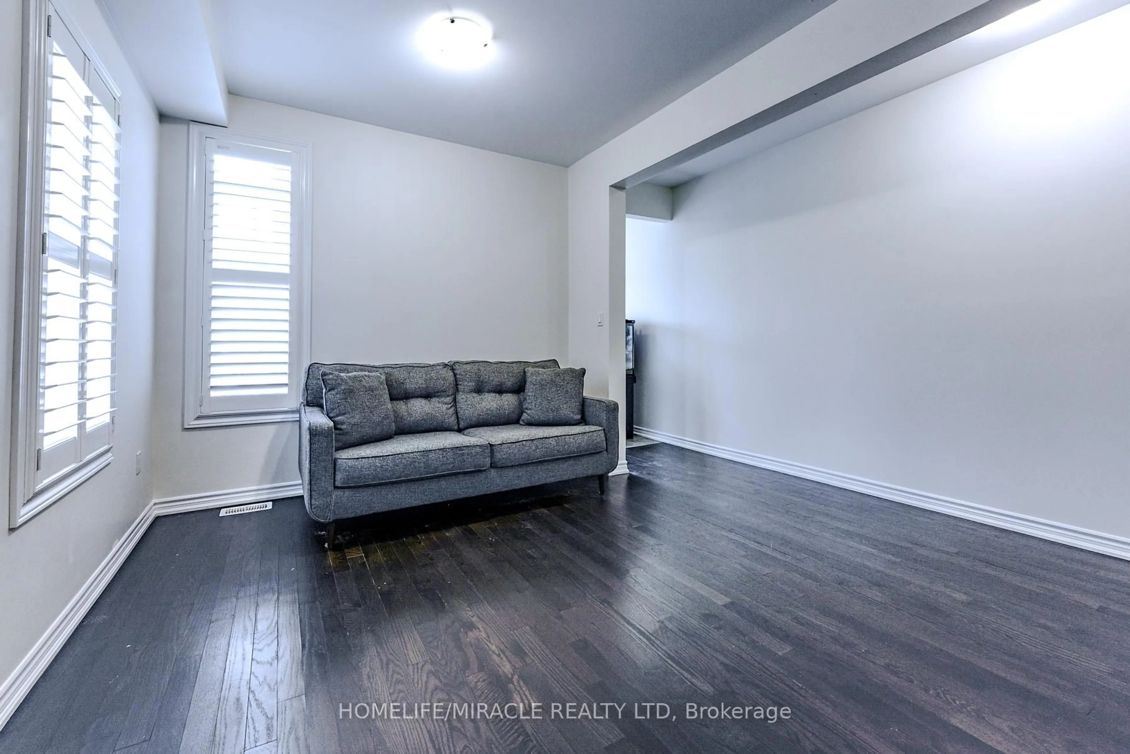 Living room with furniture, wood/laminate floor for 61 Bucksaw St, Brampton Ontario L7A 4P8