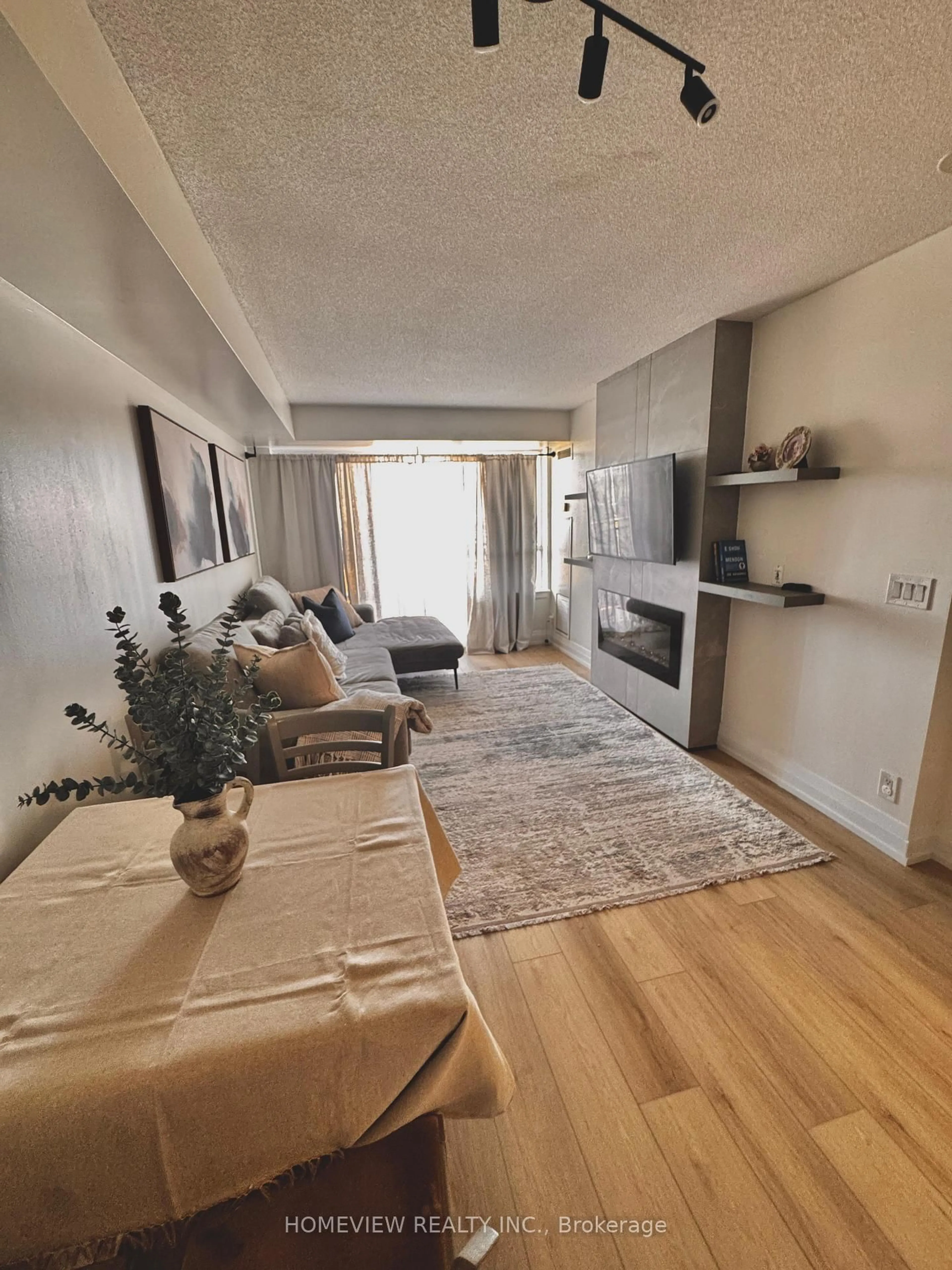 Living room with furniture, wood/laminate floor for 1070 Sheppard Ave #1211, Toronto Ontario M3J 0G8