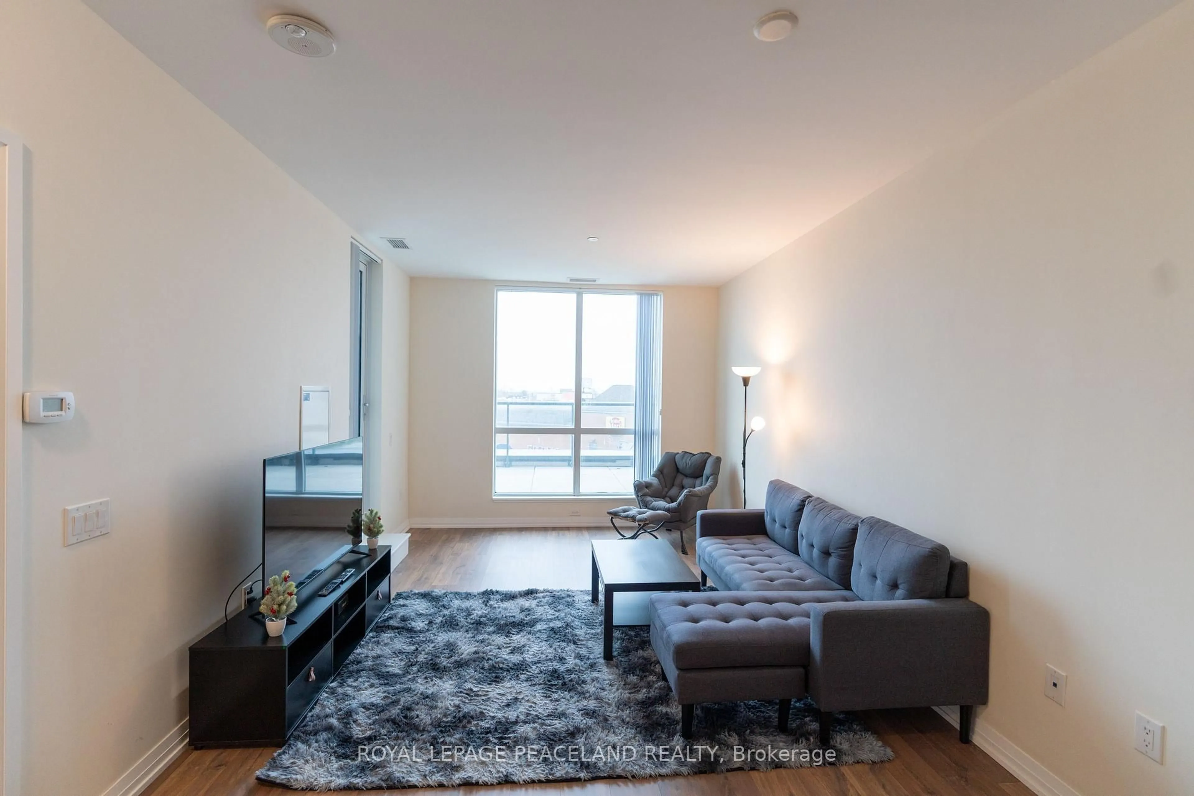 Living room with furniture, unknown for 50 Thomas Riley Rd #207, Toronto Ontario M9B 0C5