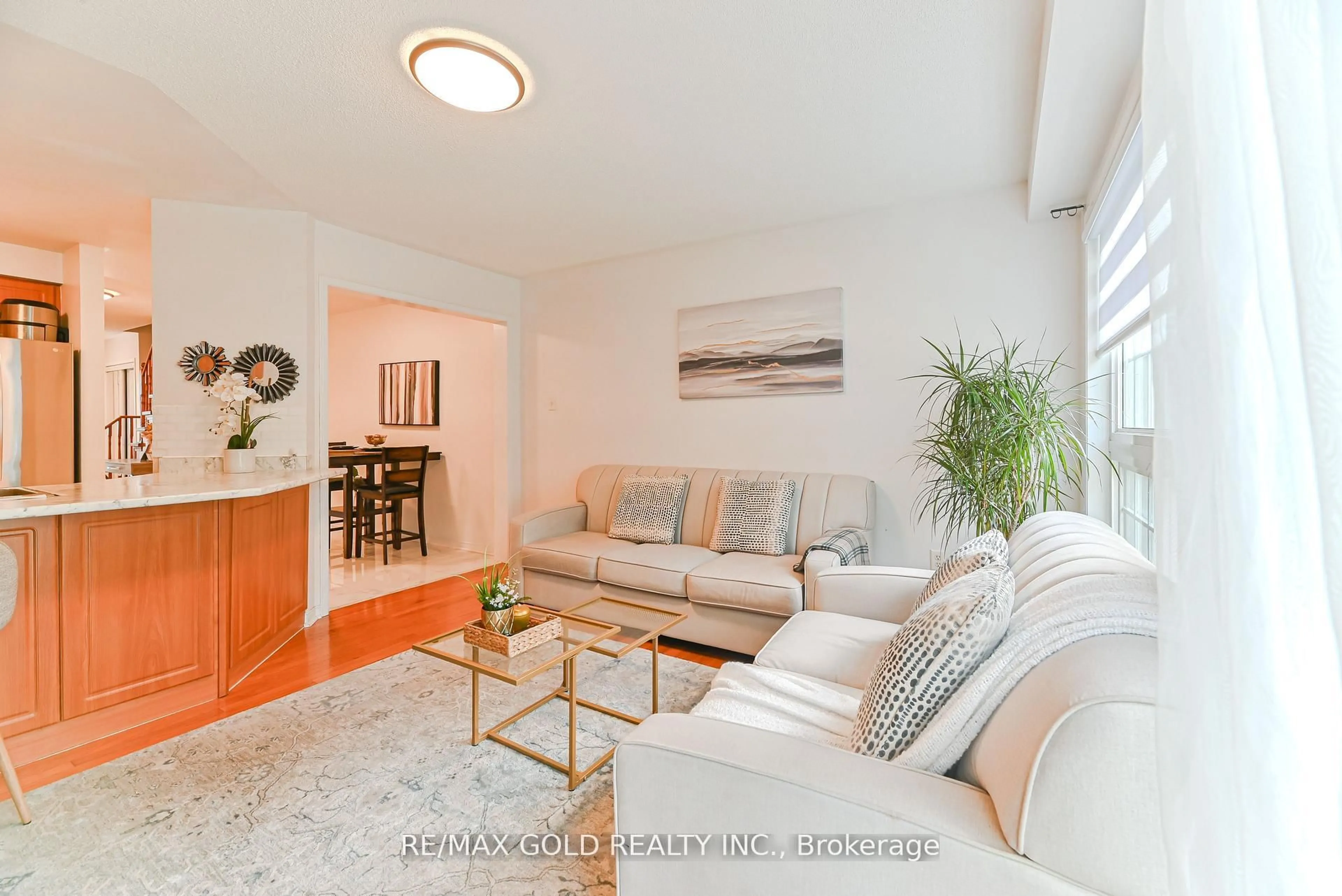 Living room with furniture, wood/laminate floor for 28 Plum Hollow Crt, Brampton Ontario L6R 2T5