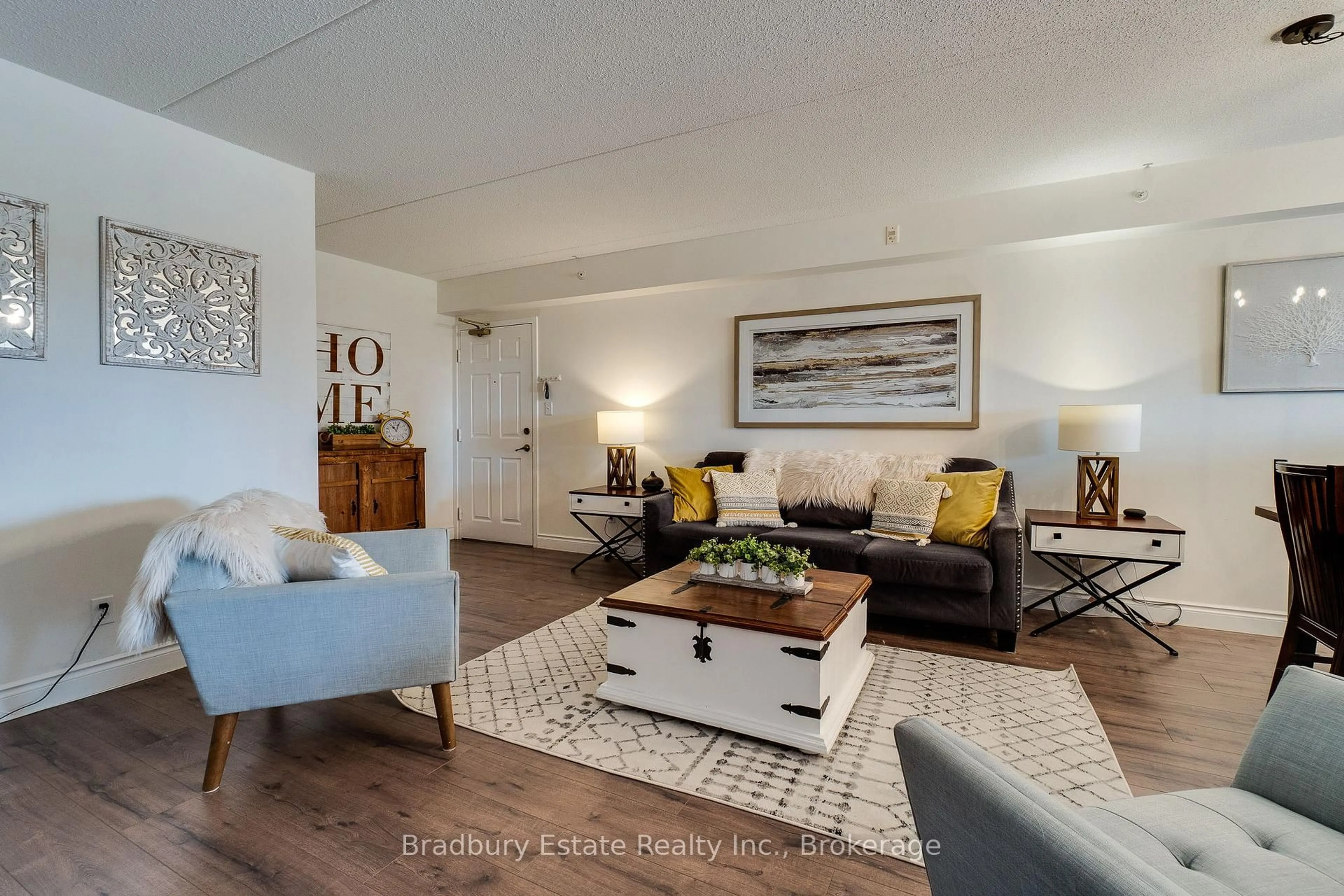 Living room with furniture, wood/laminate floor for 2045 Appleby Line #305, Burlington Ontario L7L 7G9