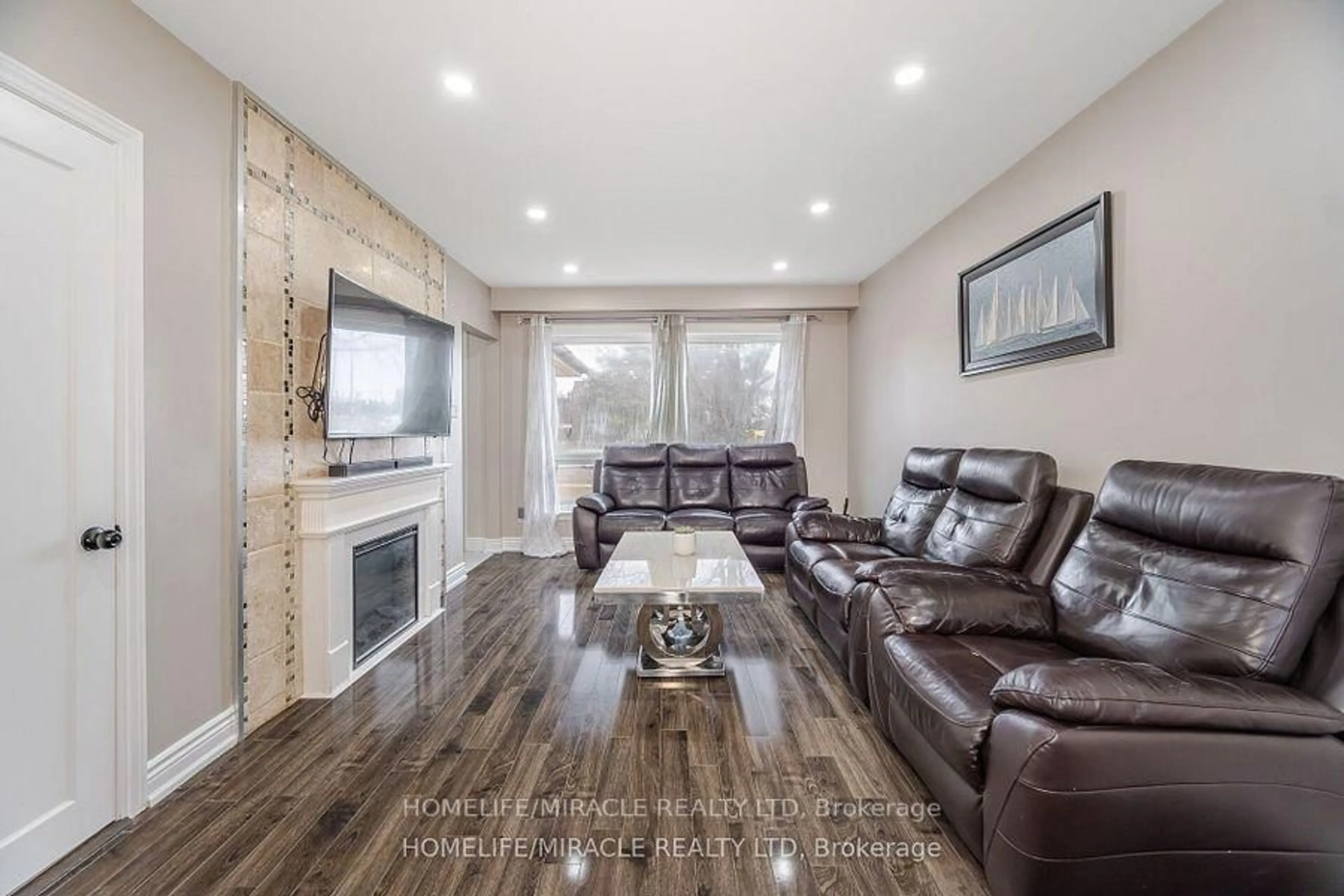 Living room with furniture, wood/laminate floor for 345 Silverstone Dr, Toronto Ontario M9V 3J8