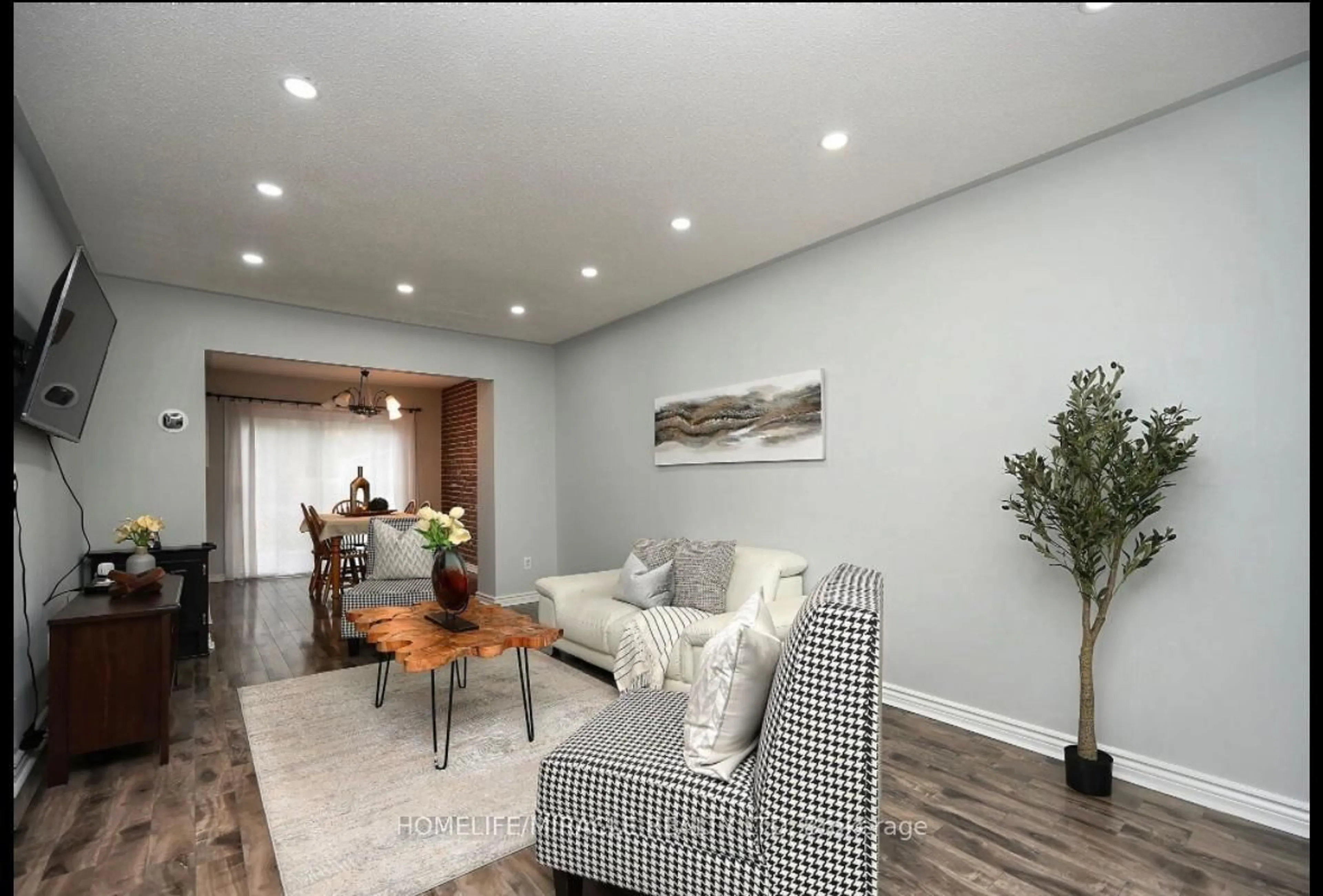 Living room with furniture, wood/laminate floor for 58 Crawford Dr, Brampton Ontario L6V 2C7