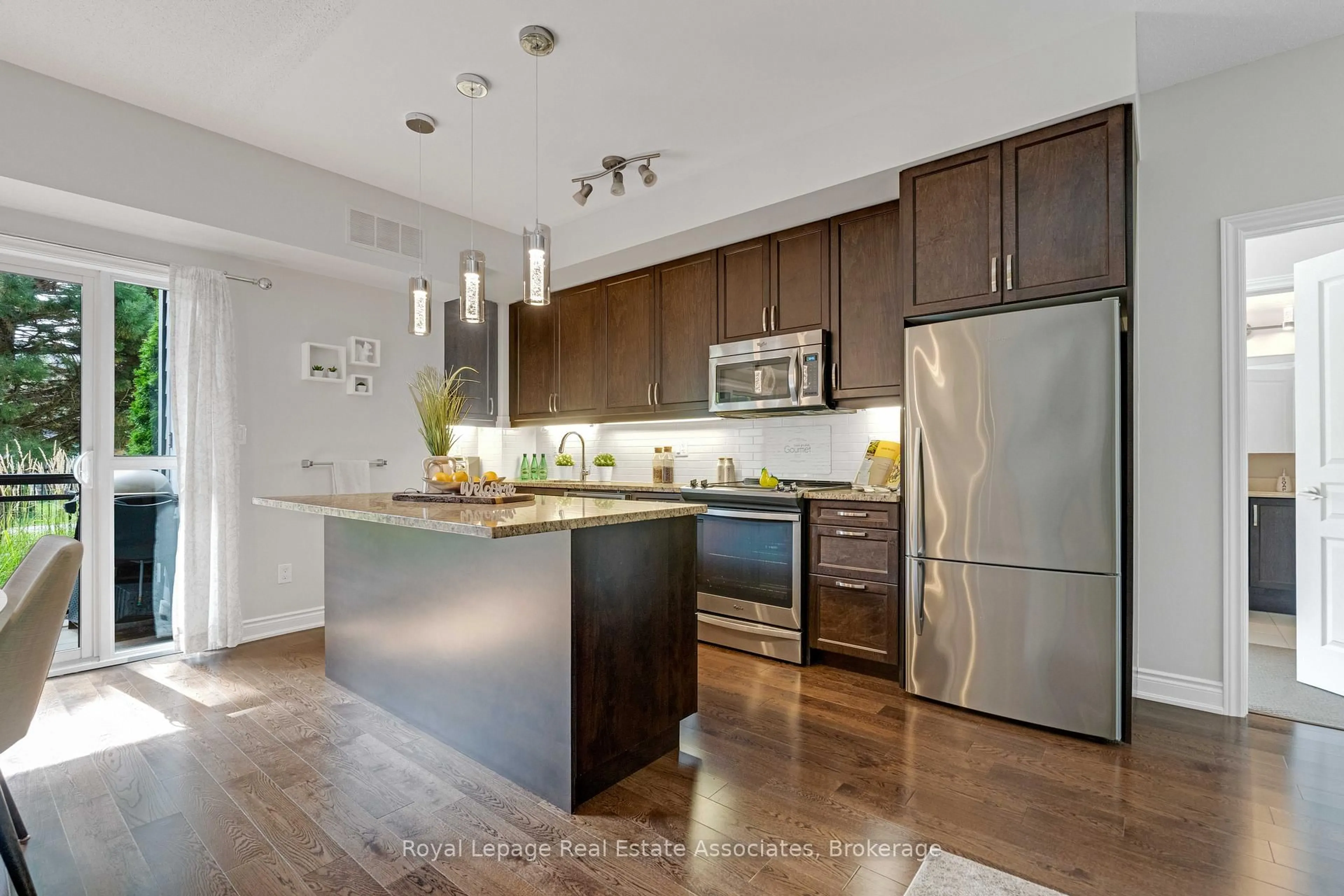 Open concept kitchen, wood/laminate floor for 3170 Erin Mills Pkwy #108, Mississauga Ontario L5L 0B6