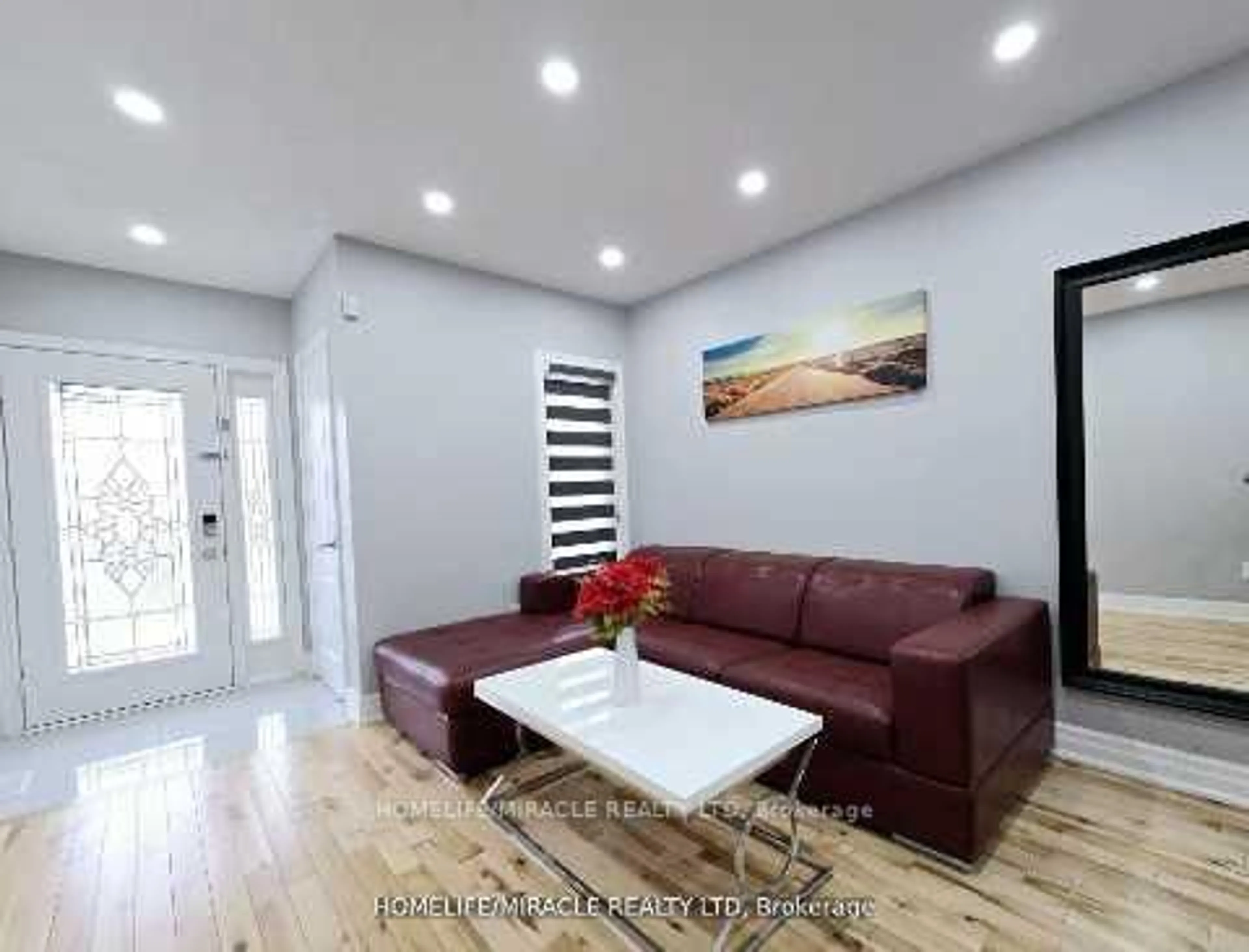 Living room with furniture, wood/laminate floor for 33 Atira Ave, Brampton Ontario L7A 3V1