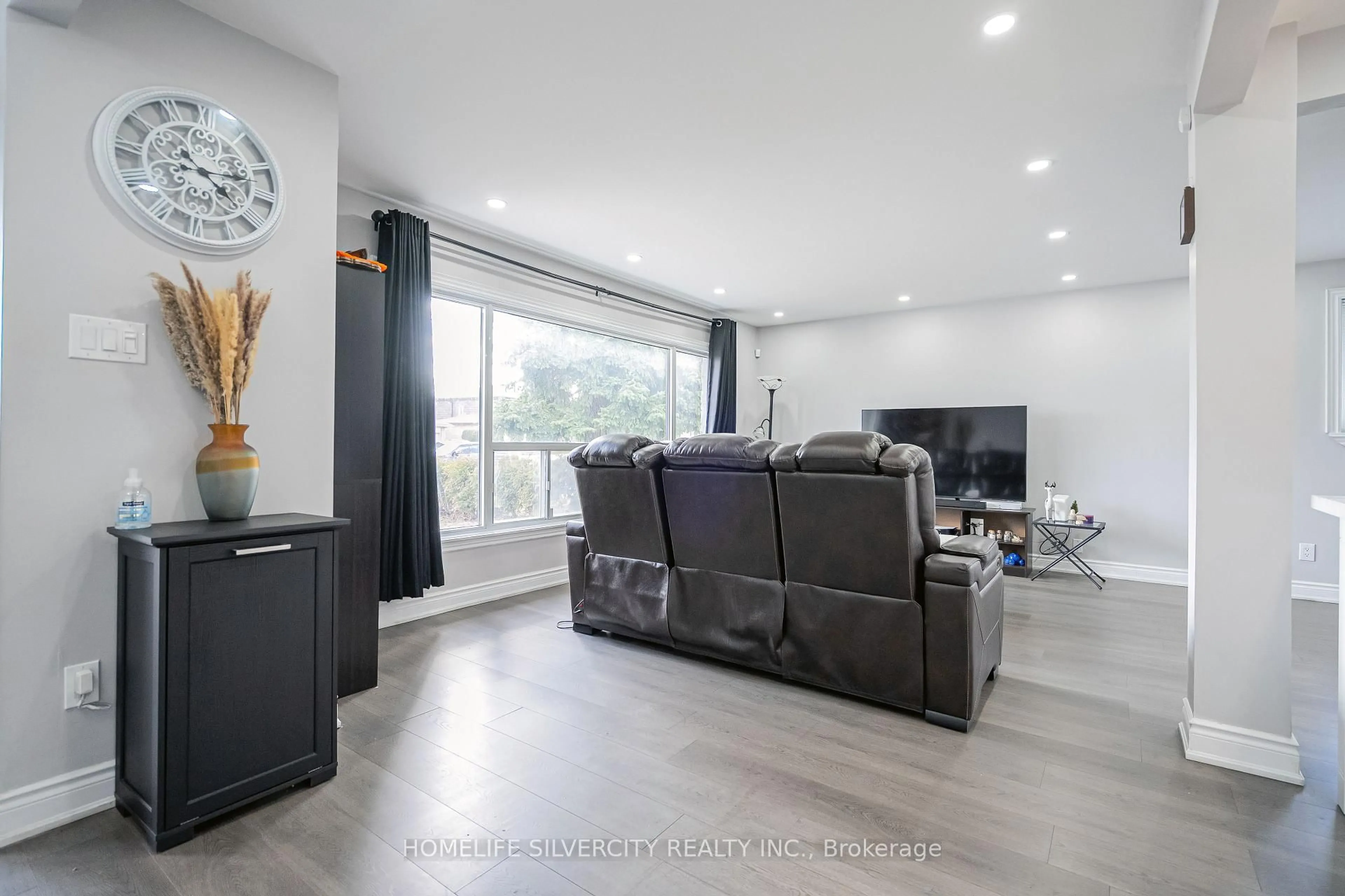 Living room with furniture, wood/laminate floor for 72 Brookland Dr, Brampton Ontario L6T 2M5
