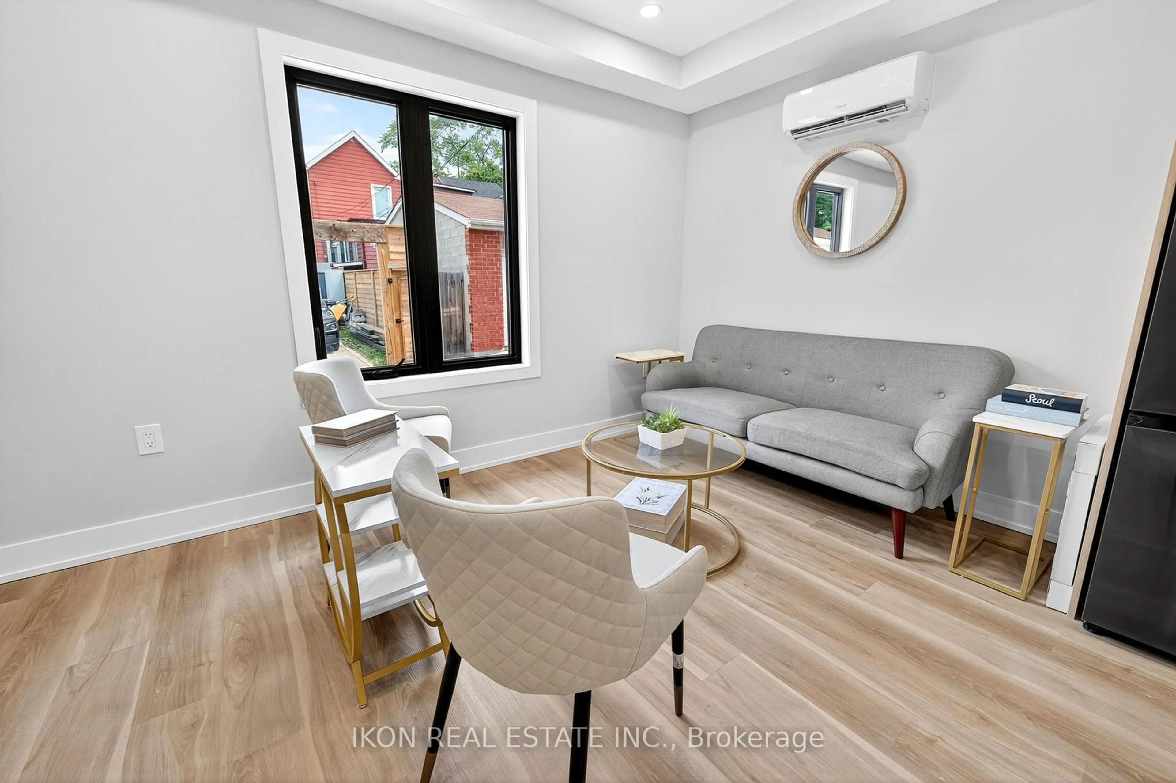 Living room with furniture, wood/laminate floor for 477 Lane South Dupont East Dalaware Lane, Toronto Ontario M6H 2V1