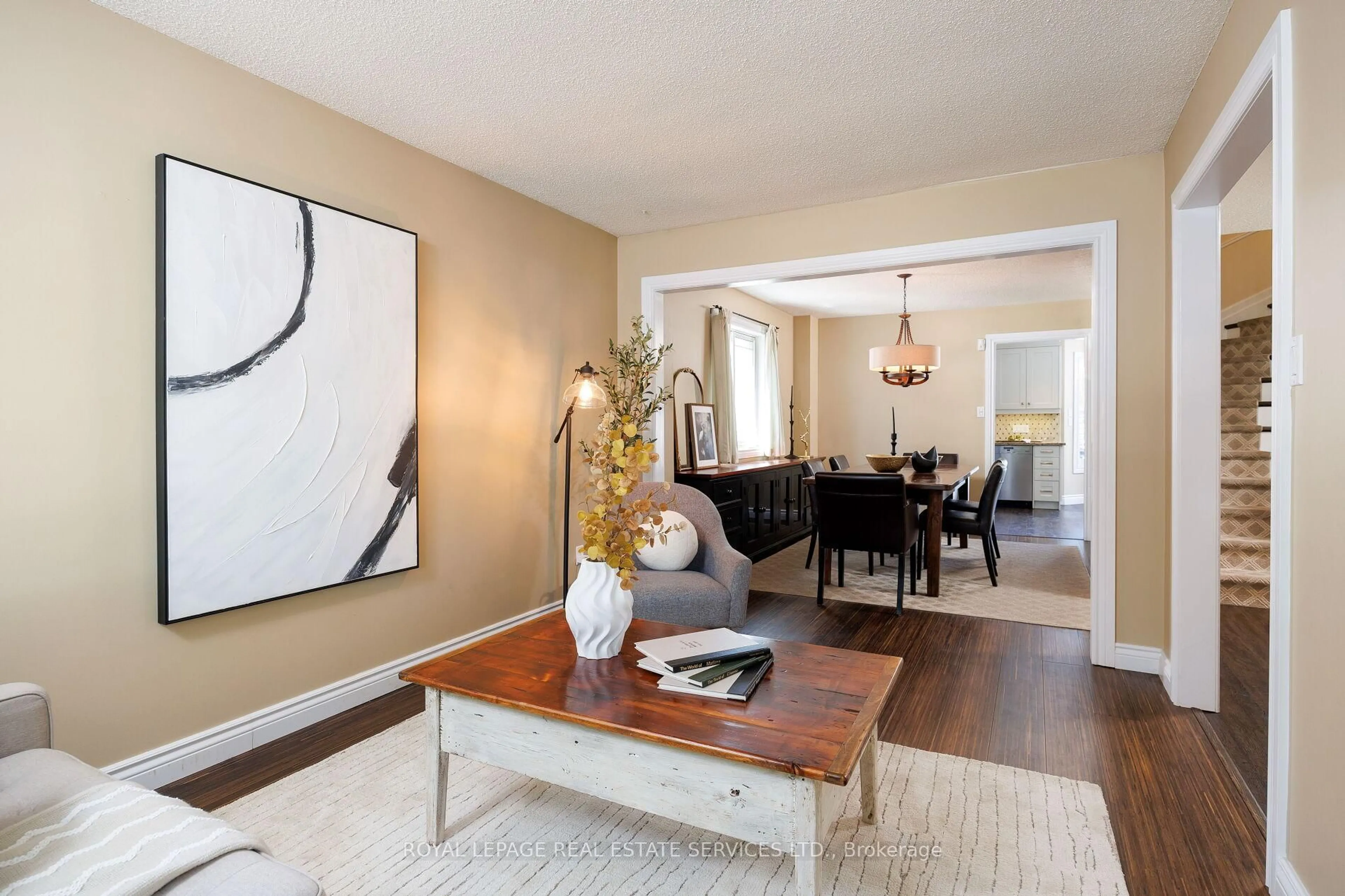 Living room with furniture, wood/laminate floor for 1559 Stoneybrook Tr, Oakville Ontario L6M 2R4