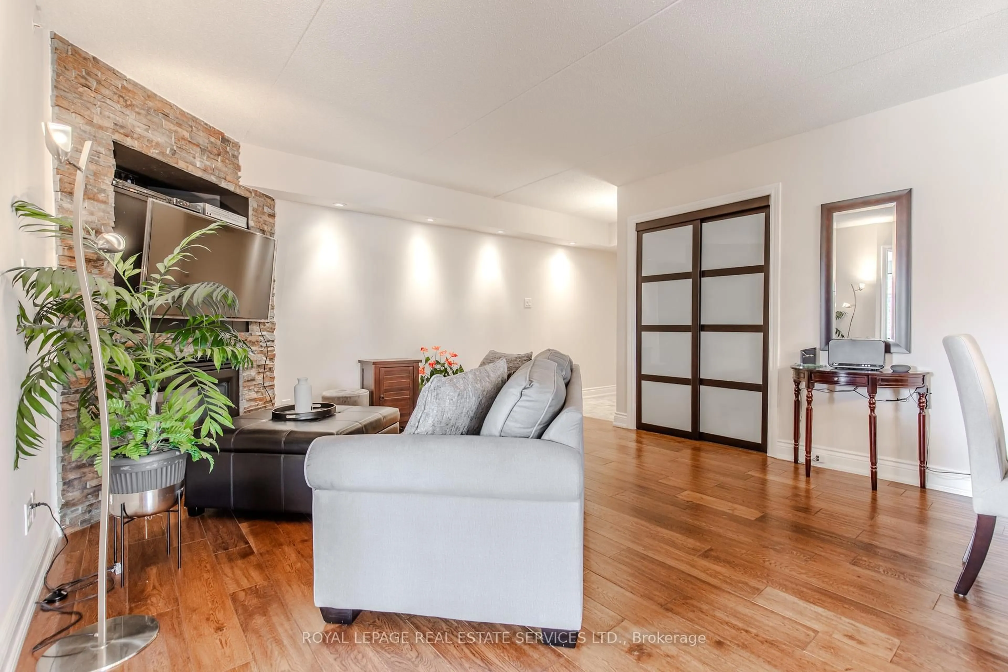 Living room with furniture, wood/laminate floor for 1451 Walker's Line #310, Burlington Ontario L7M 4P1