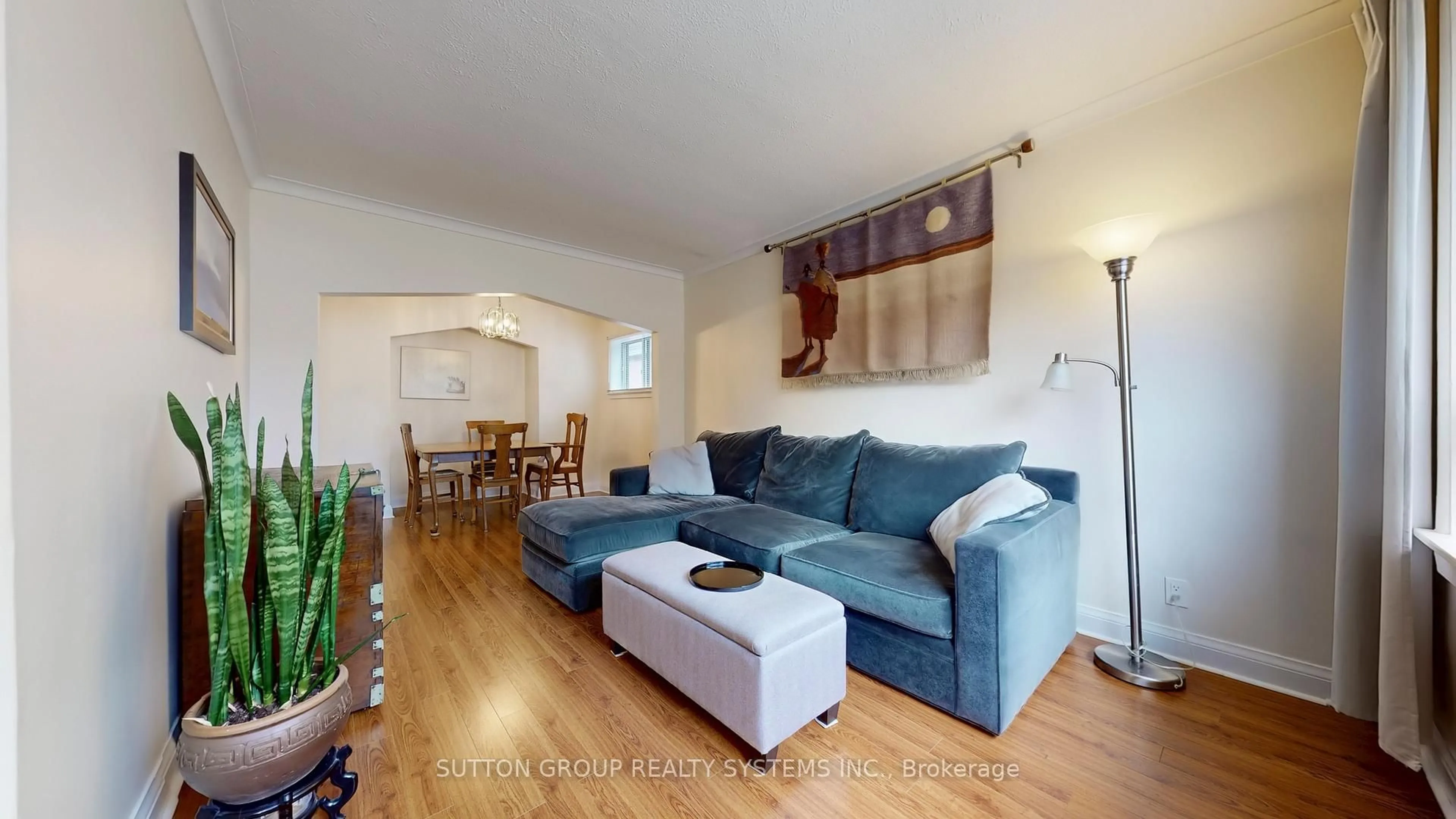 Living room with furniture, wood/laminate floor for 129 Lonborough Ave, Toronto Ontario M6M 1X9