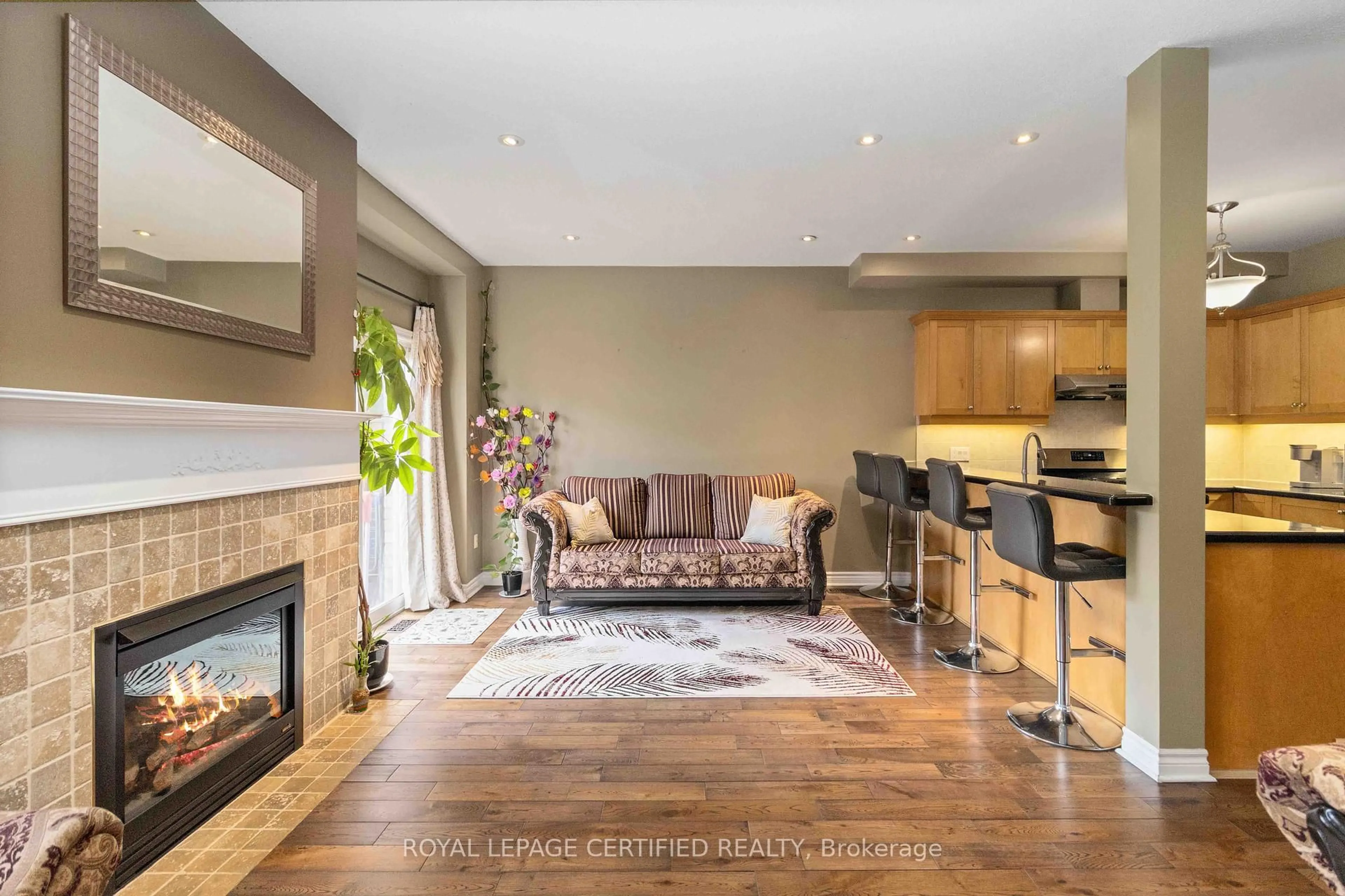 Living room with furniture, wood/laminate floor for 7385 Magistrate Terr #6, Mississauga Ontario L5W 1W8